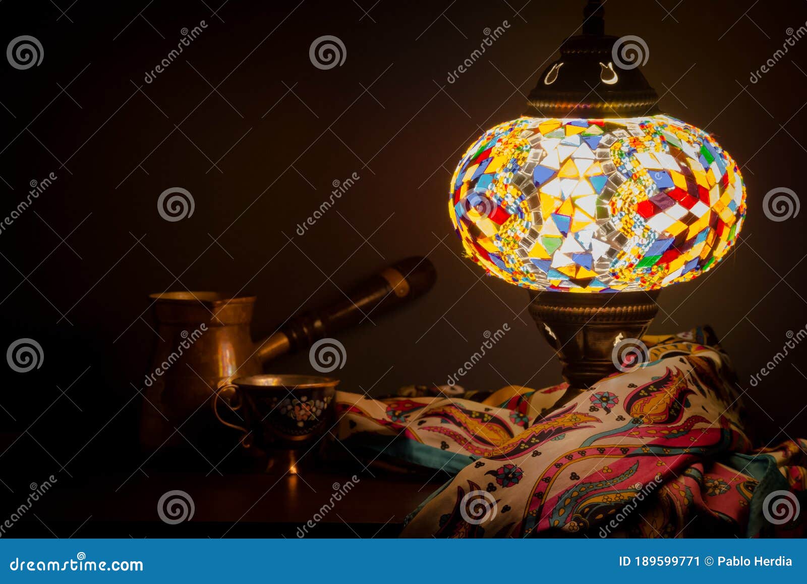 turkish cafe illuminated by turkish lamp and silk scarf