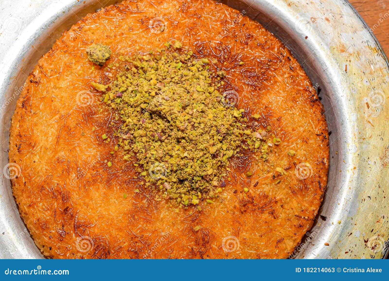 turkish dessert kunefe with pistachio powder. kunafa, kadayif with pistachio powder and cheese hot