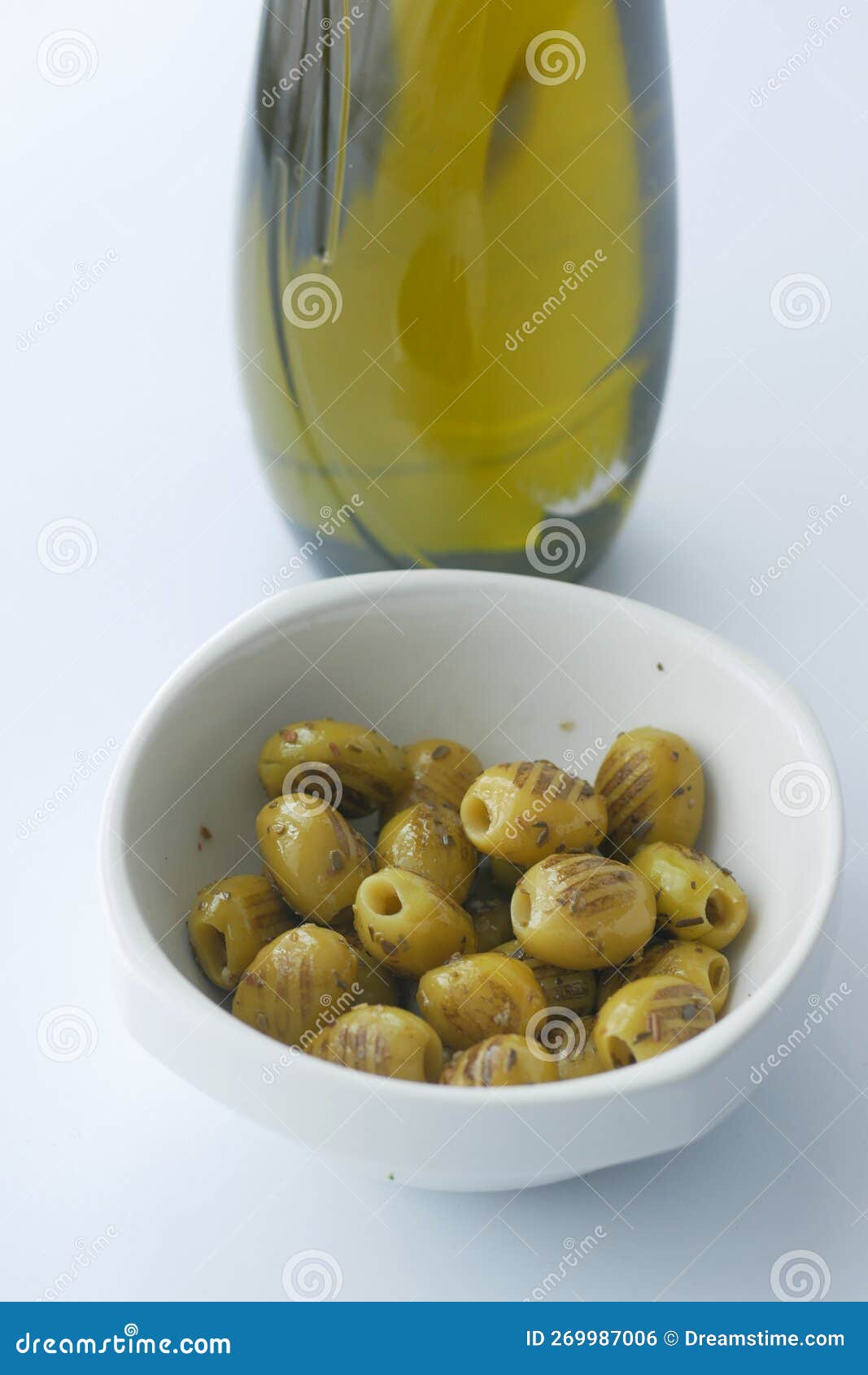 Turkish Grilled Olives with Olive and Oil Jar on Table Stock Photo