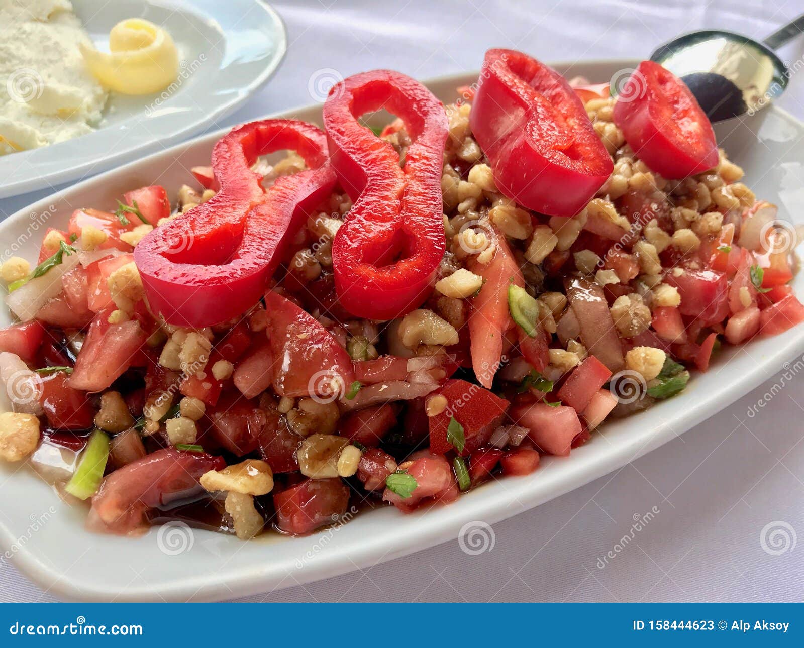 turkish salad gavurdagi with walnut, tomatoes and sliced red peppers slices