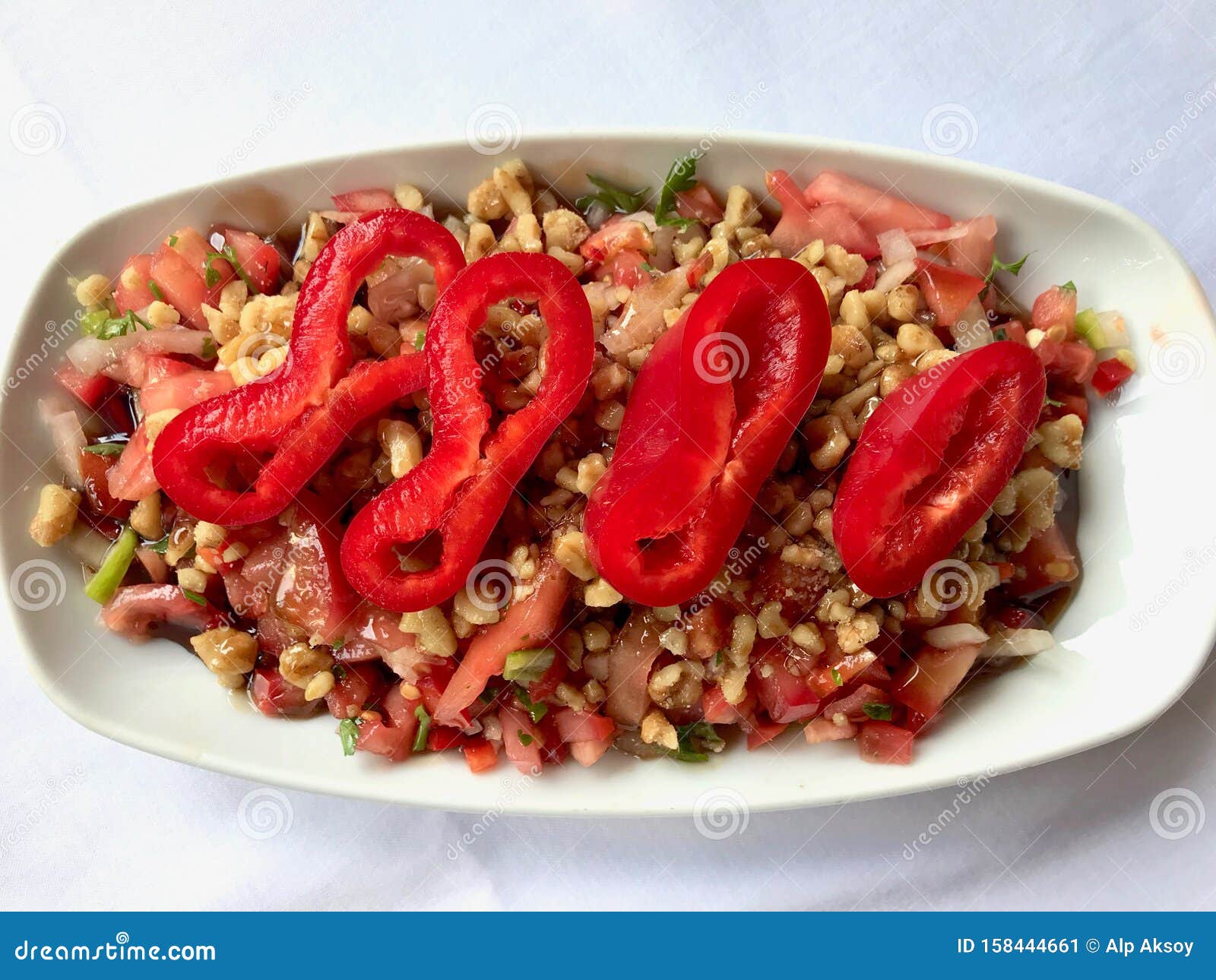 turkish salad gavurdagi with walnut, tomatoes and sliced red peppers slices