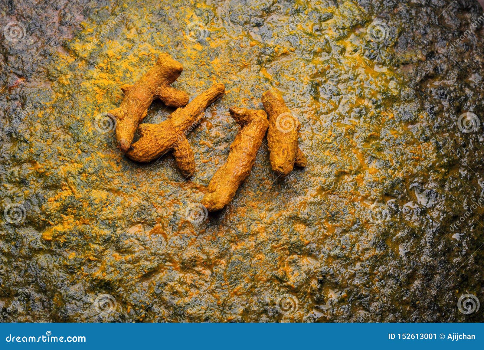 turmeric roots kept on stone background