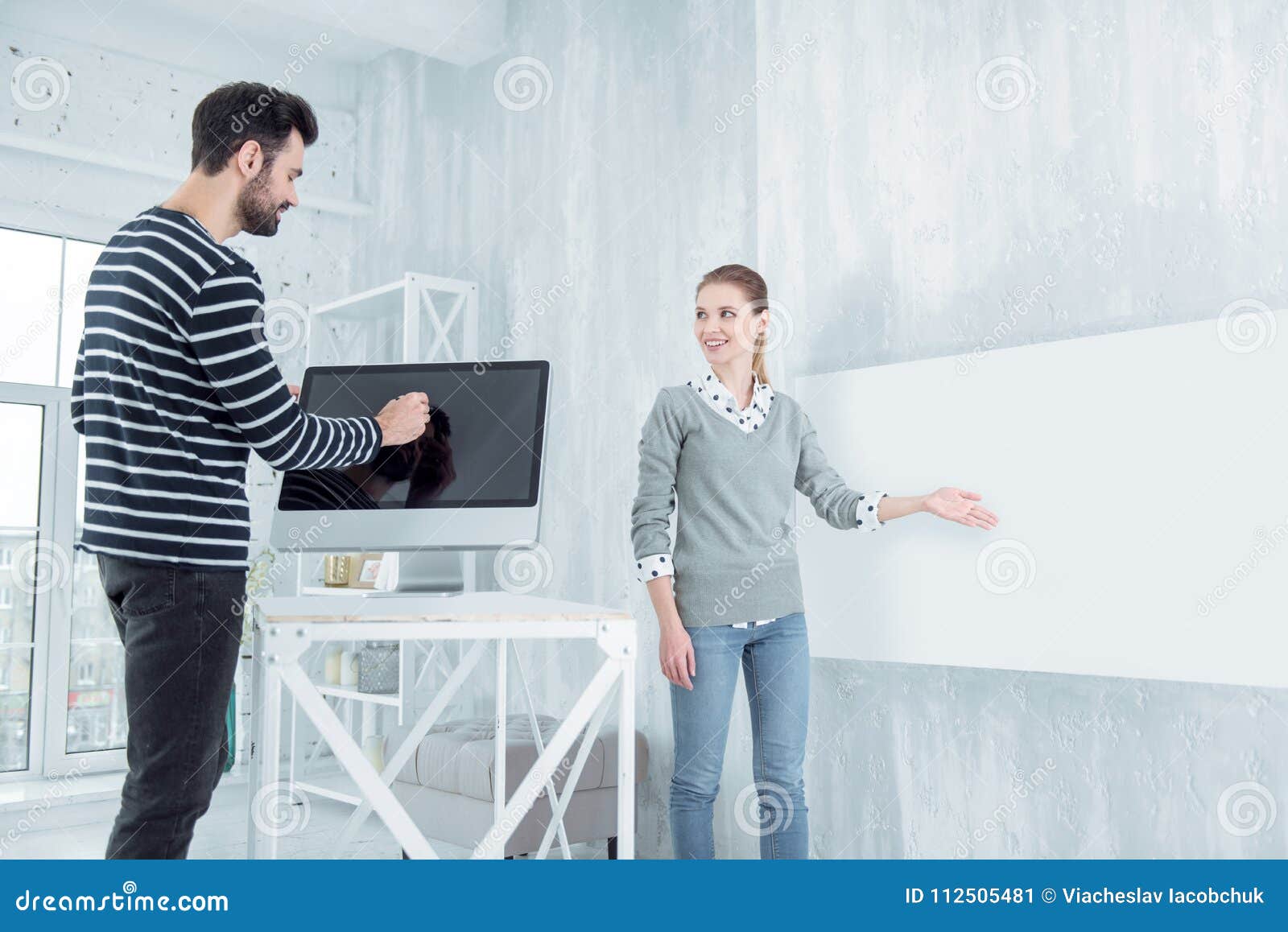serious office worker standing near gadget
