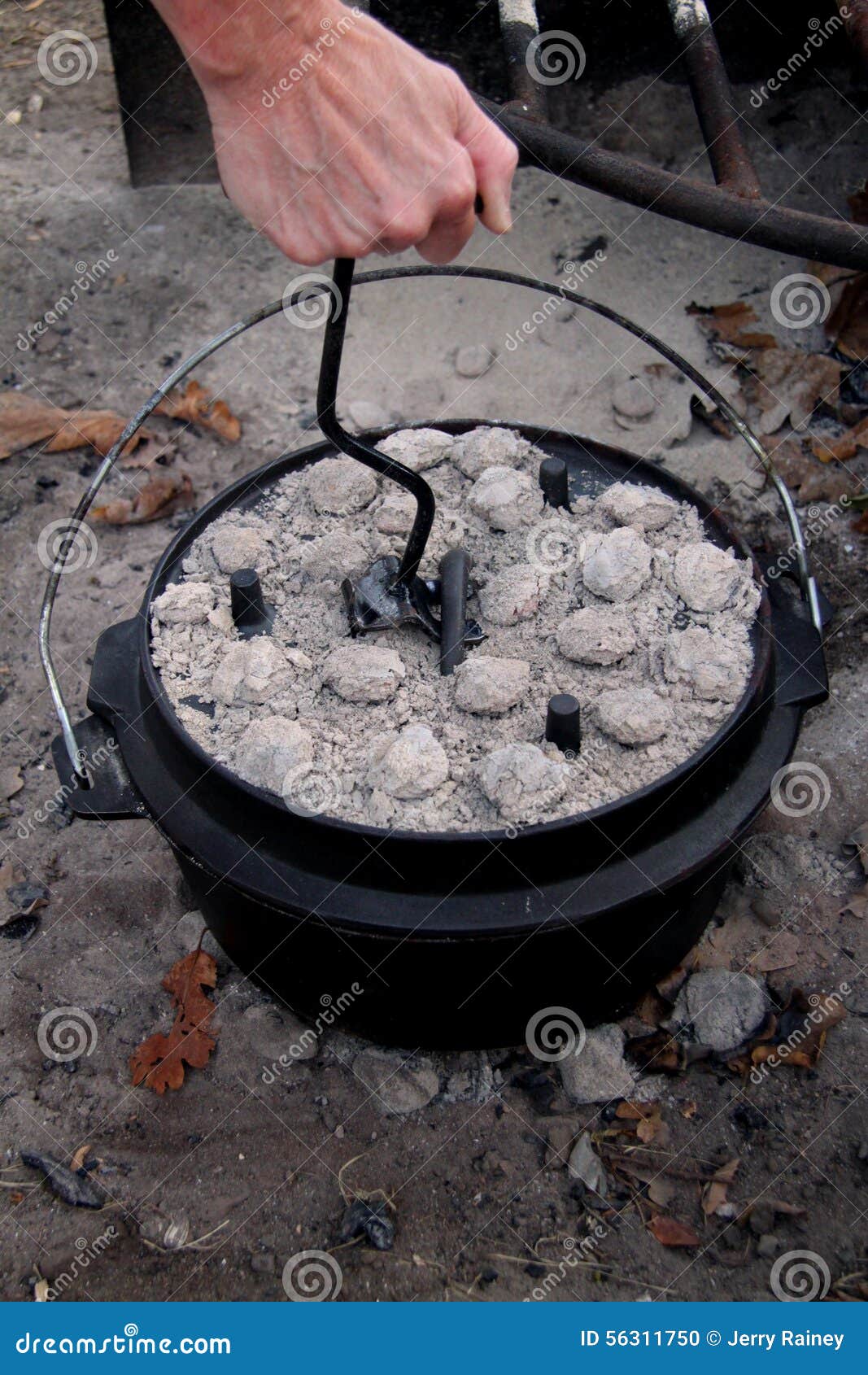Turning a dutch oven lid stock photo. Image of camp, briquettes 56311750
