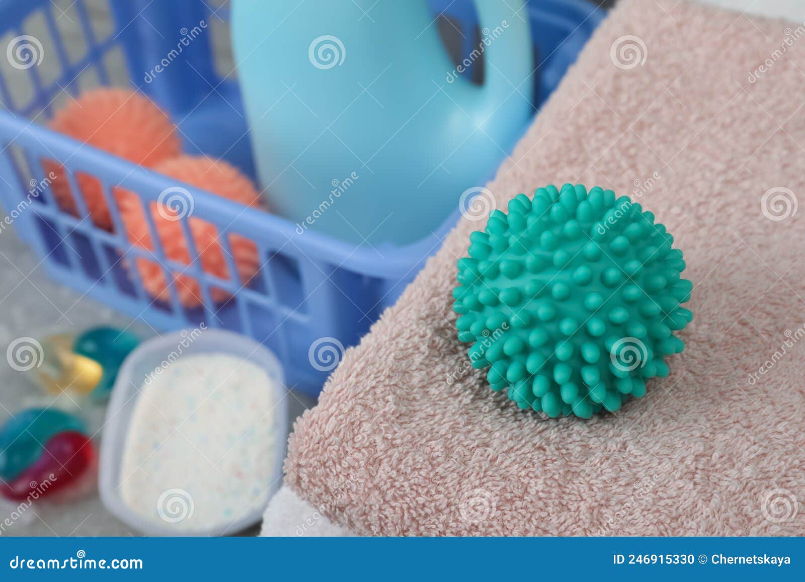 Turquoise Dryer Ball and Clean Towels on Table, Closeup Stock Photo