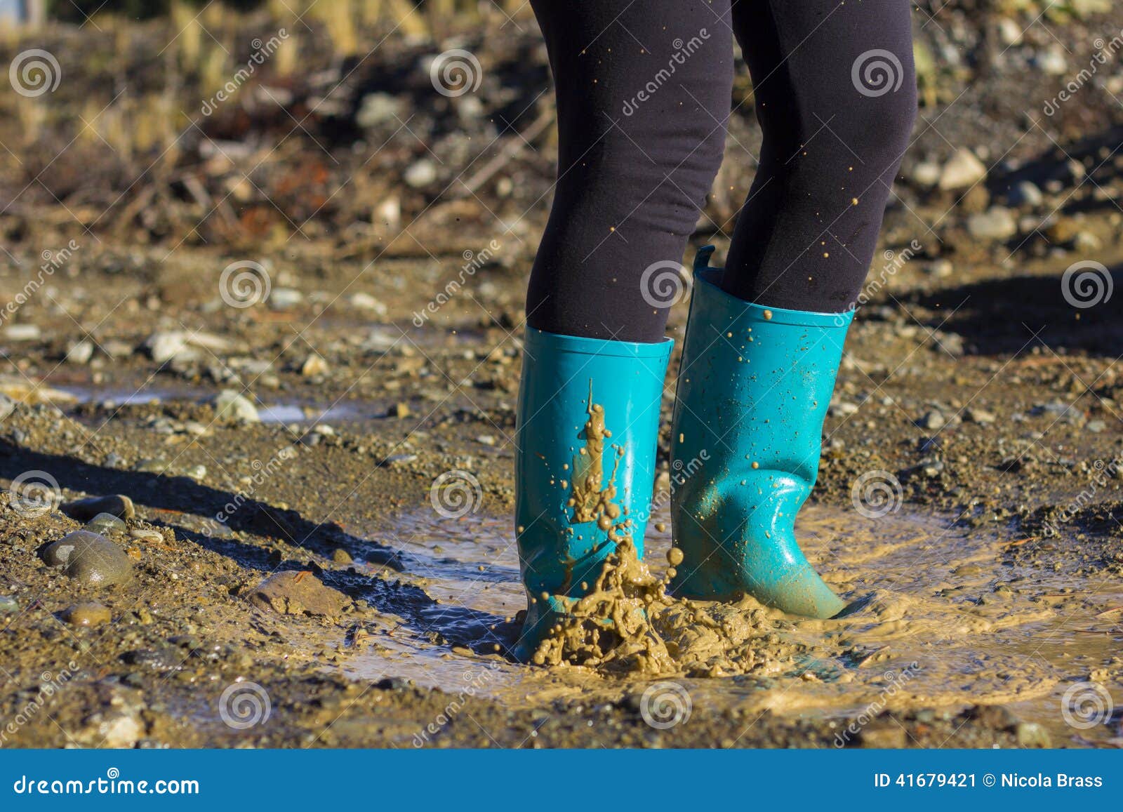 Turquoise Gumboots Splashing in a Puddle Stock Image - Image of droplet ...