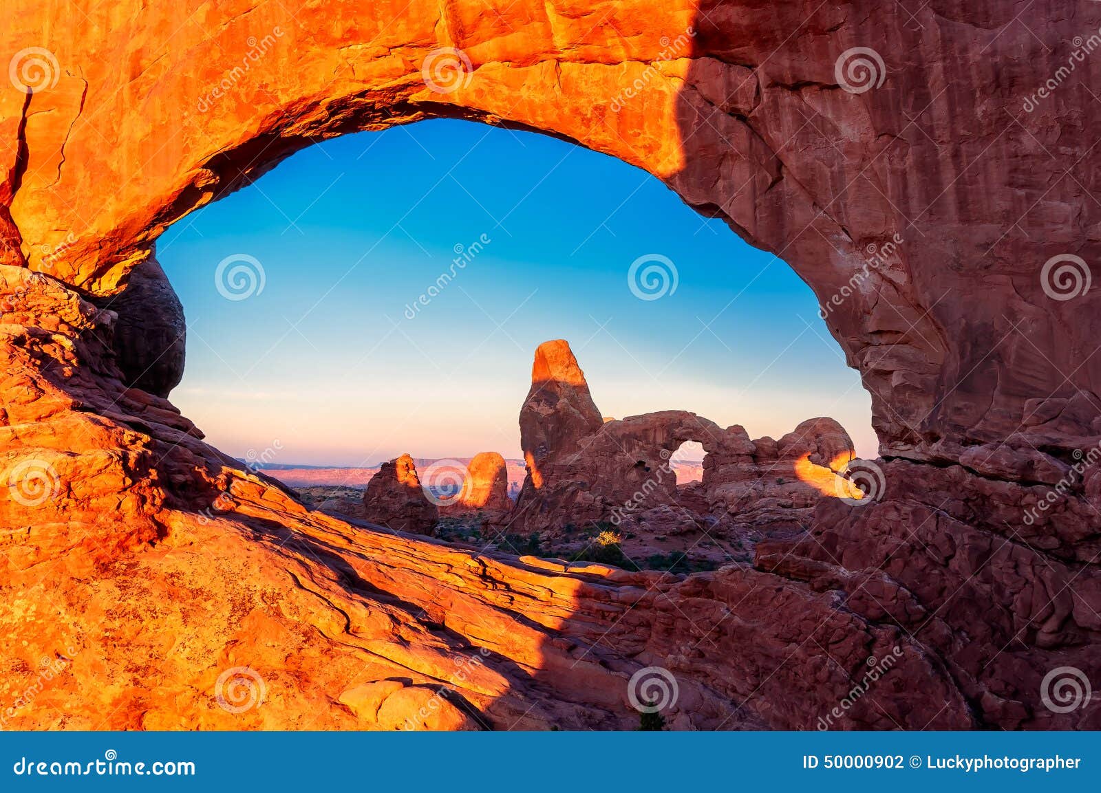 turret arch through the north window at sunrise in arches national park near moab, utah