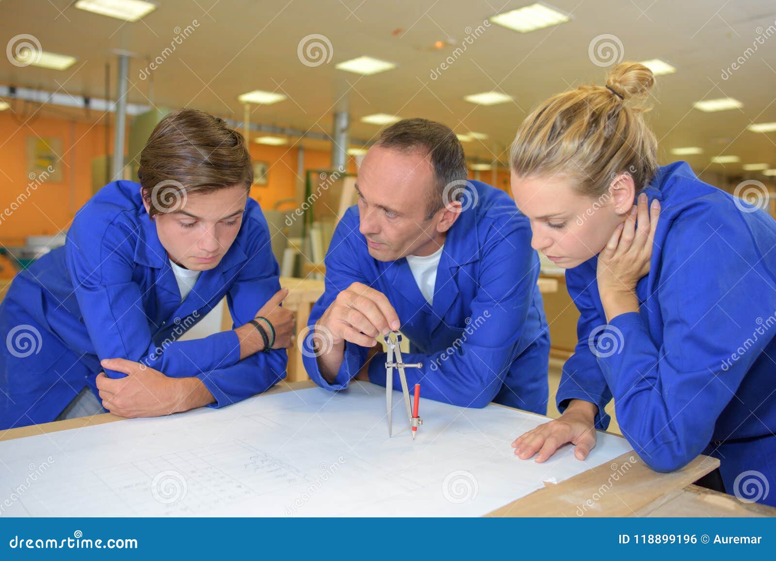 Tutor Using Compass with Two Trainees Stock Photo Image of female