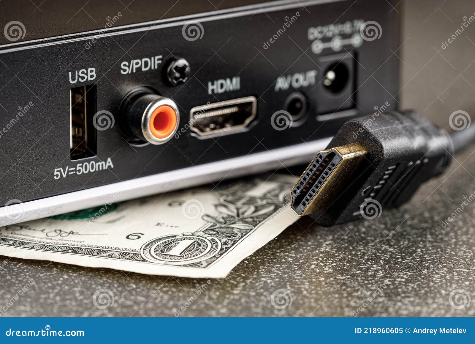 TV Box with a Disconnected Hdmi Cable and a Dollar Under it Stock Image