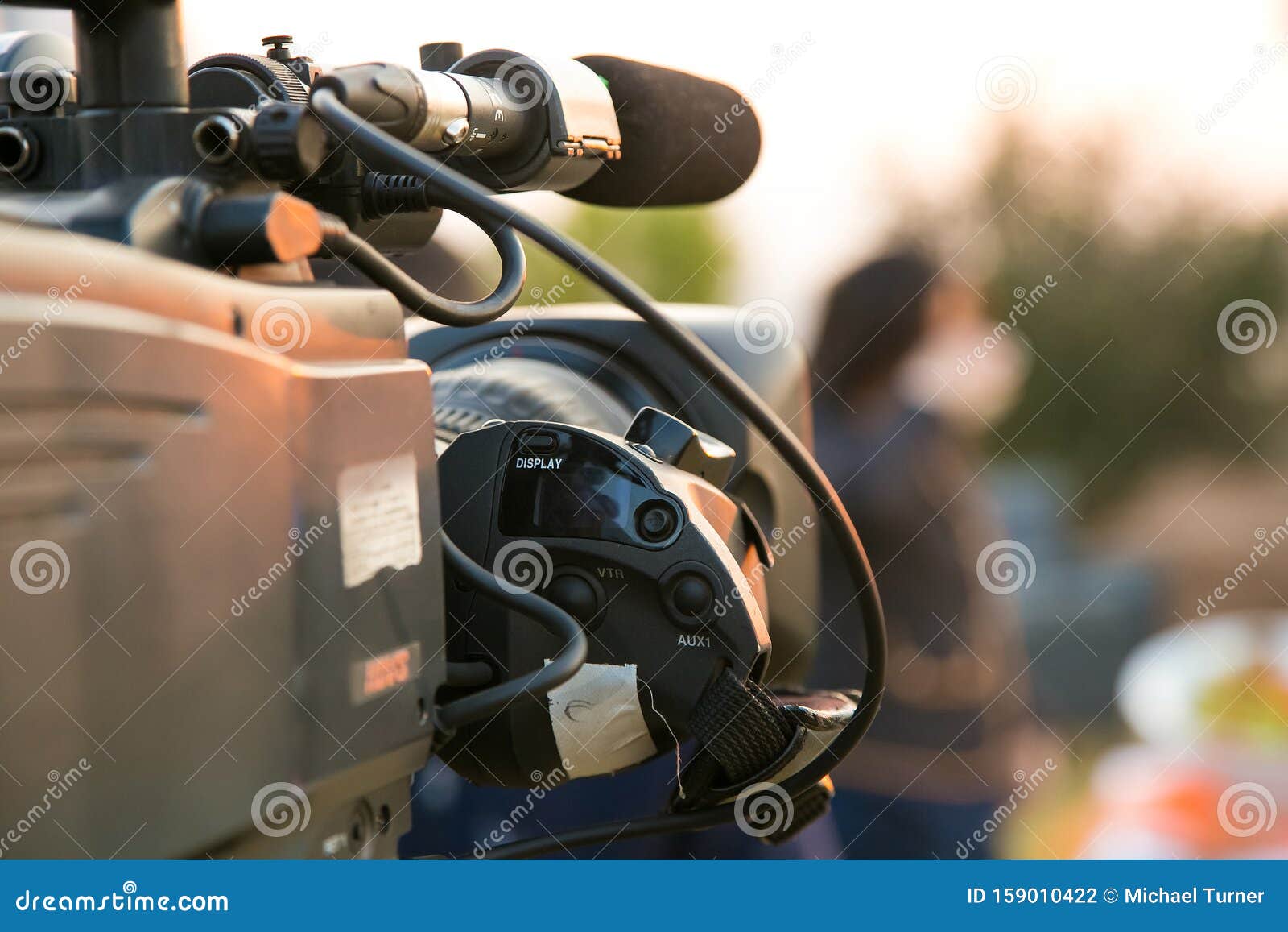 tv camera and presenter host on a live news broadcast on location
