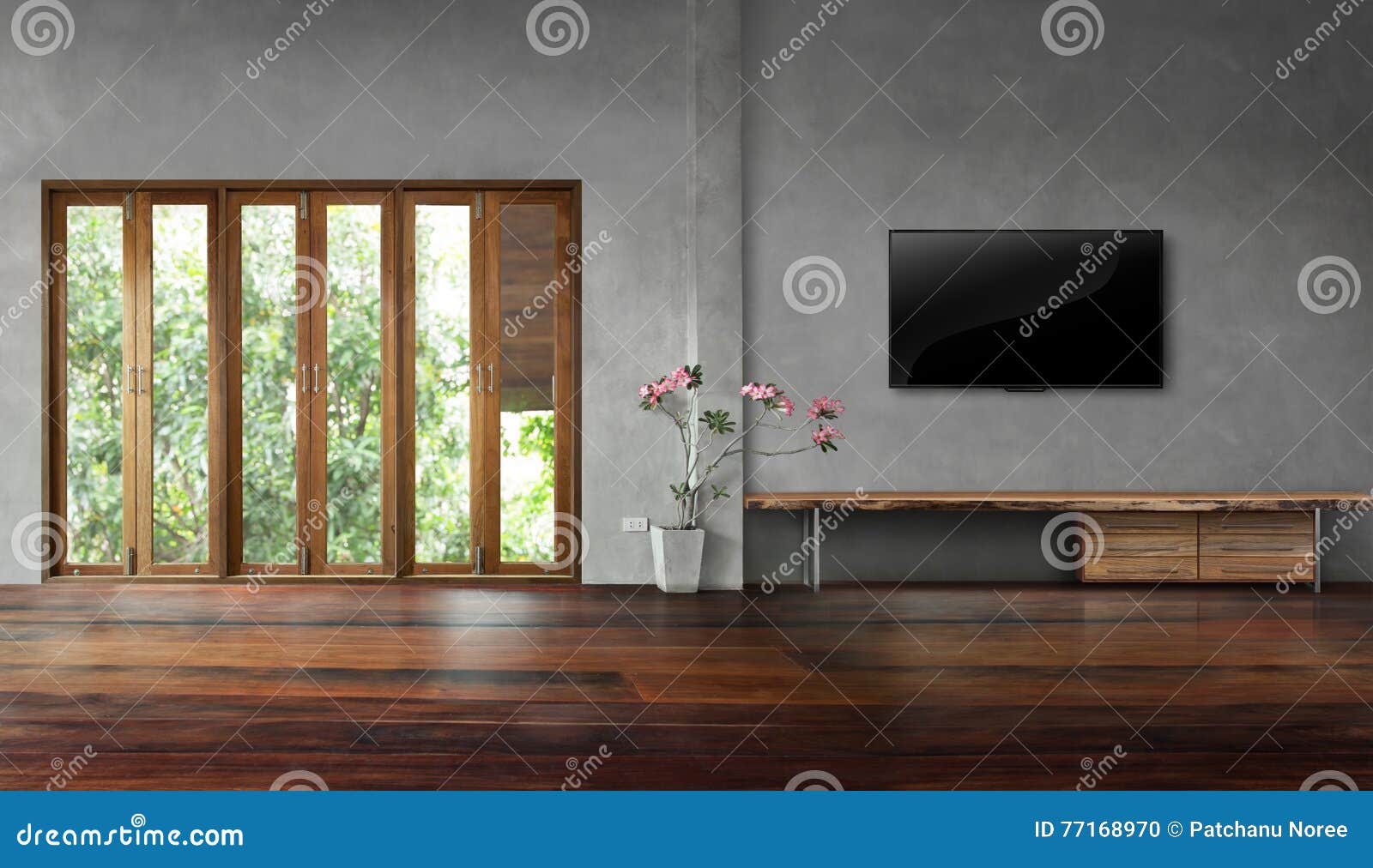 tv on concrete wall with tall windows in old wooden floors empty living room