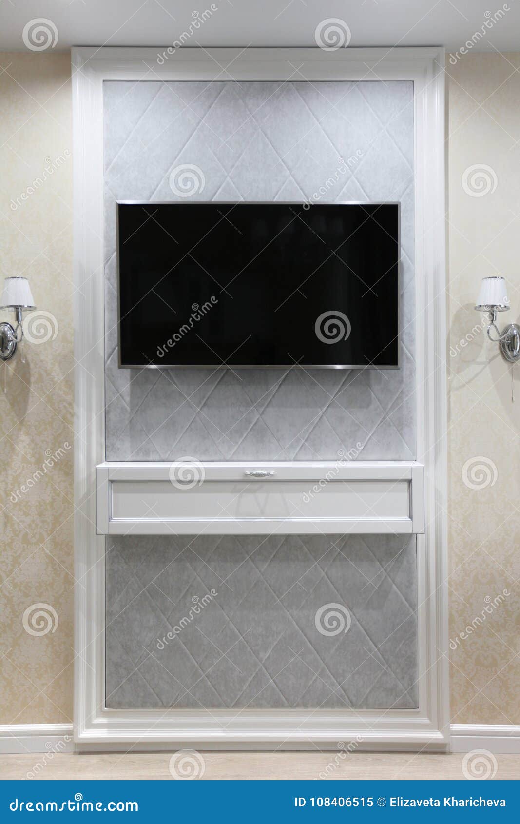 TV on the Wall with a Decor and Two Sconces on the Sides Stock Image