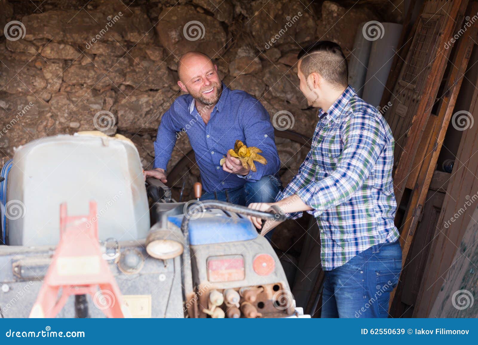 Twee bestuurders die met tractor werken. Twee mannelijke bestuurders die met tractor en het babbelen werken