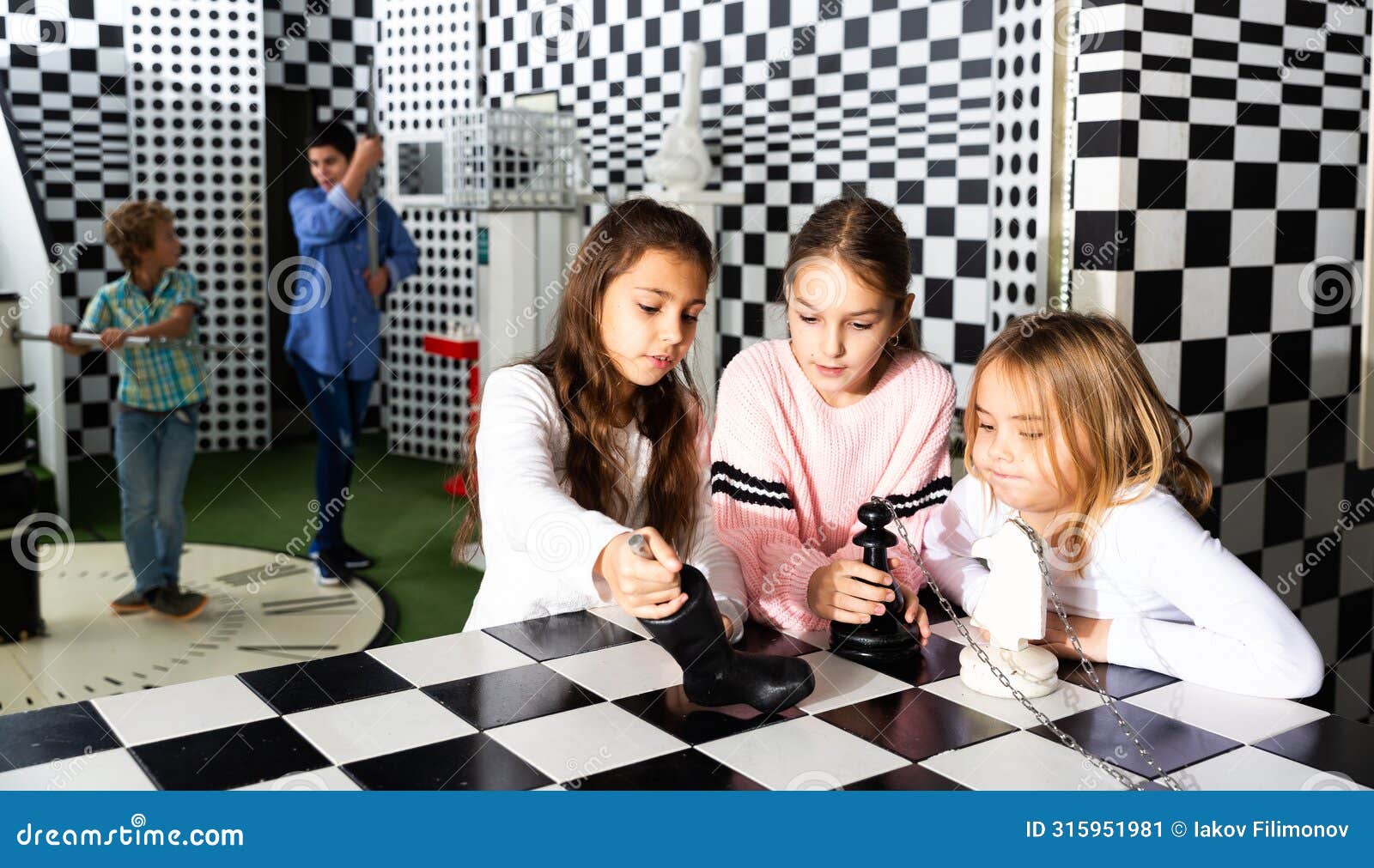 tween girls solving conundrum in quest room stylized under chessboard