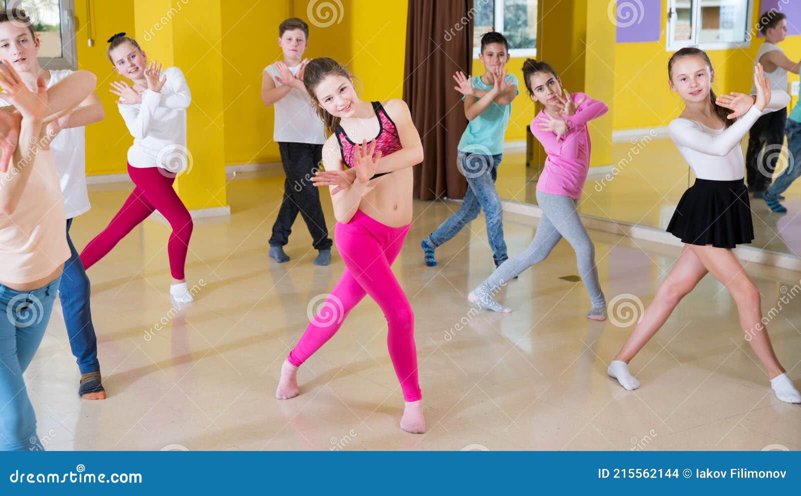 tweens exercising with coach in choreography class