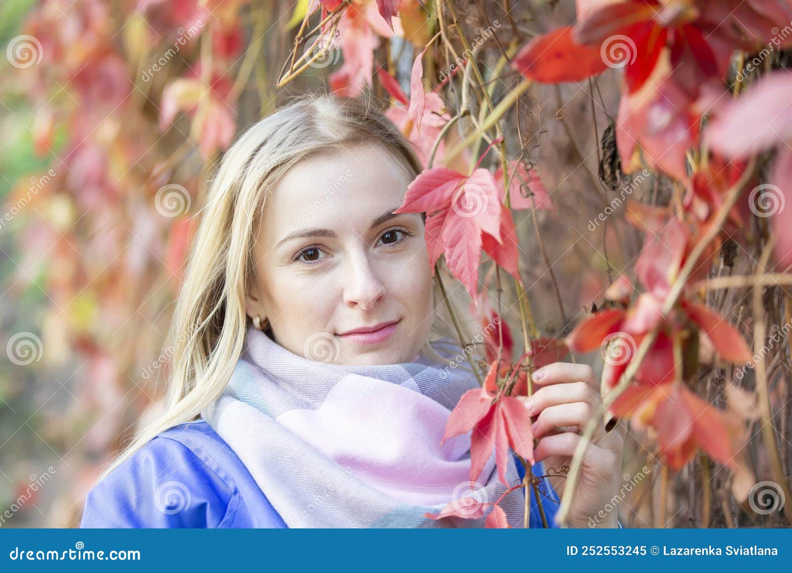 A Twenty-five-year-old Woman in Front of the Red Leaves of the Park ...