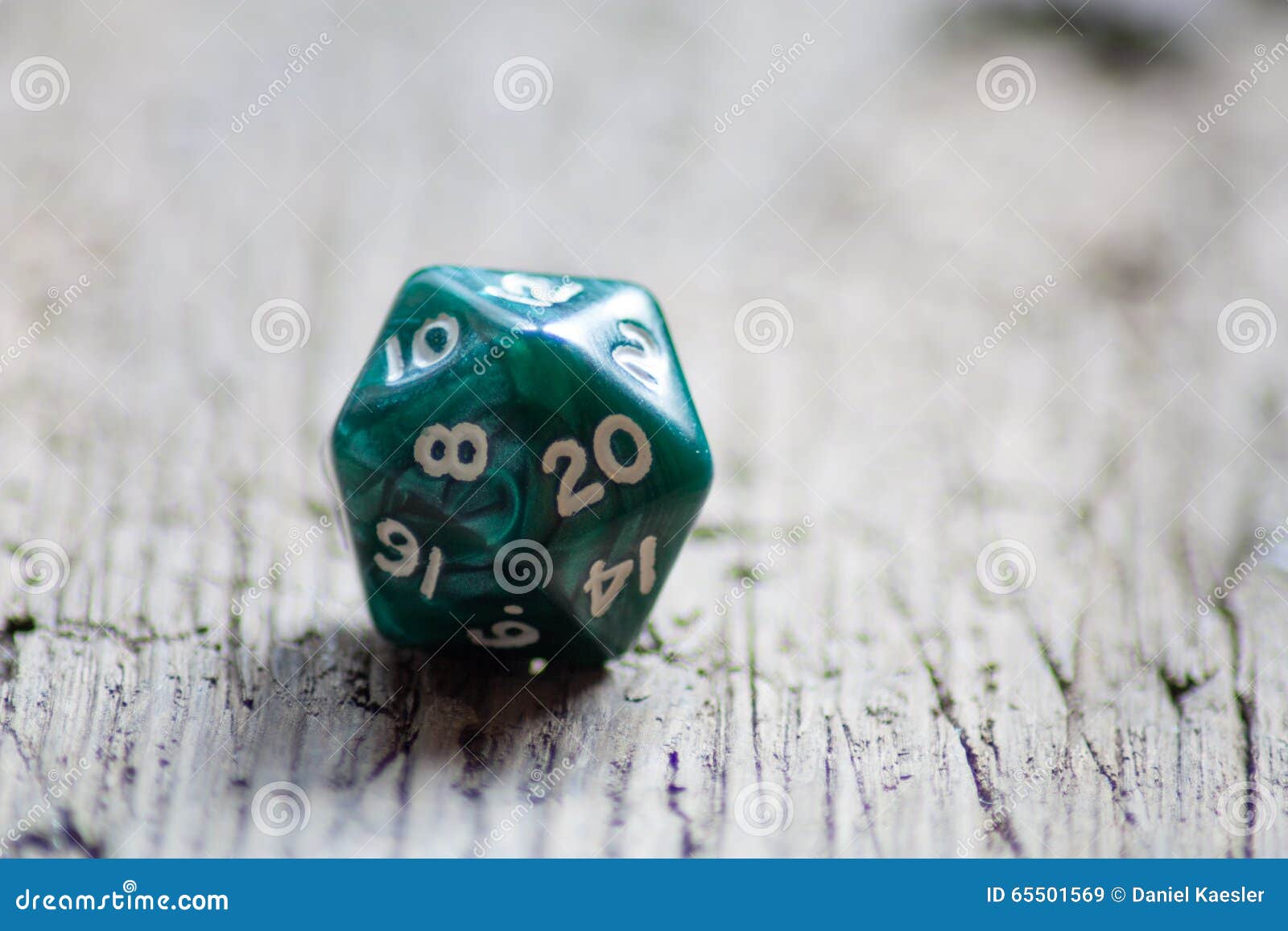 D20 Twentysided Black Metallic Die Dice On Foam Background In Bright