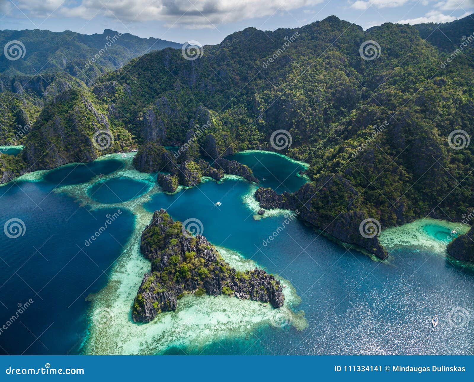 twin lagoon in coron, palawan, philippines. mountain and sea. lonely boat. tour a.