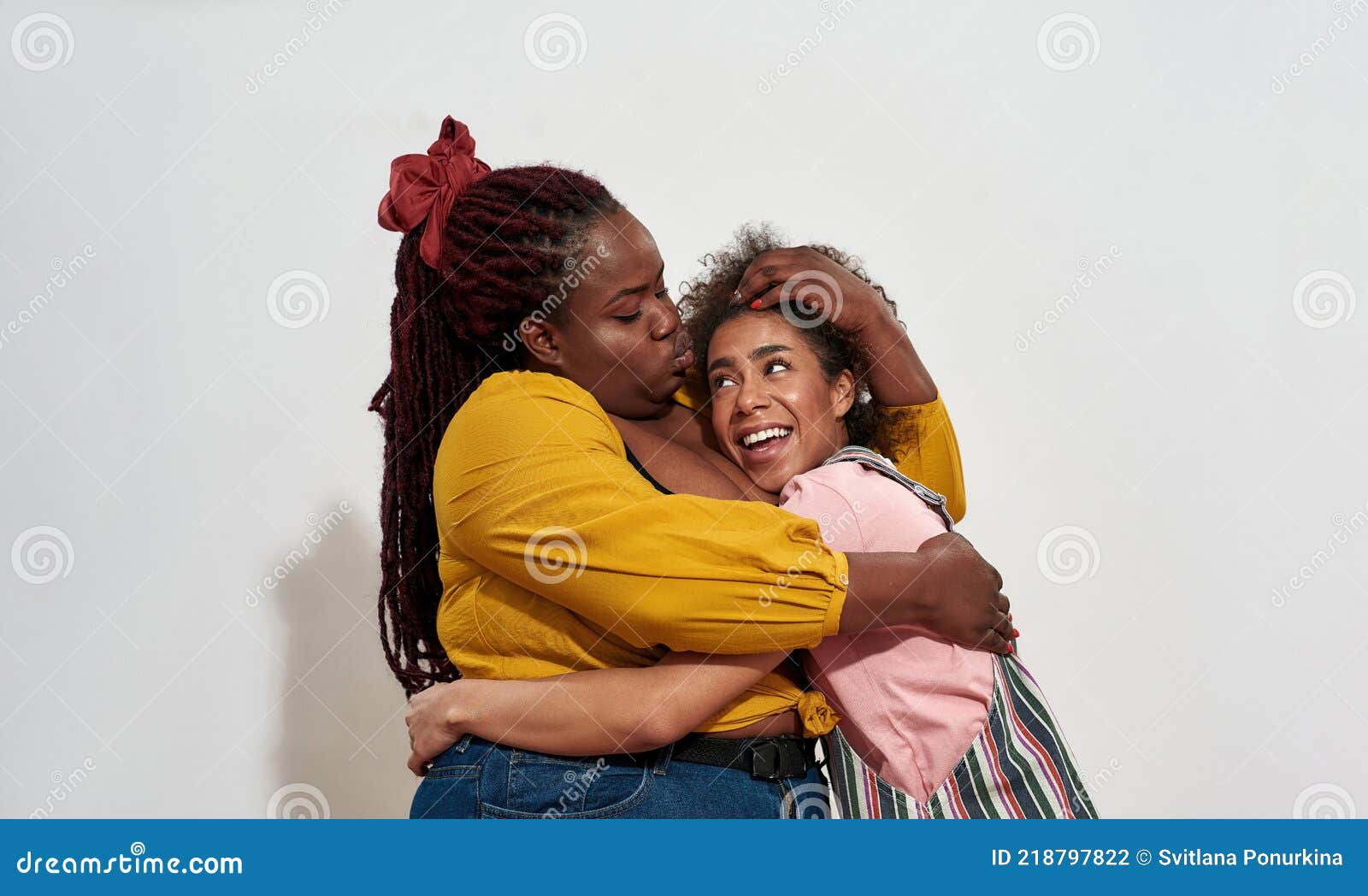 Two friendly casual women posing in style Stock Photo - Alamy