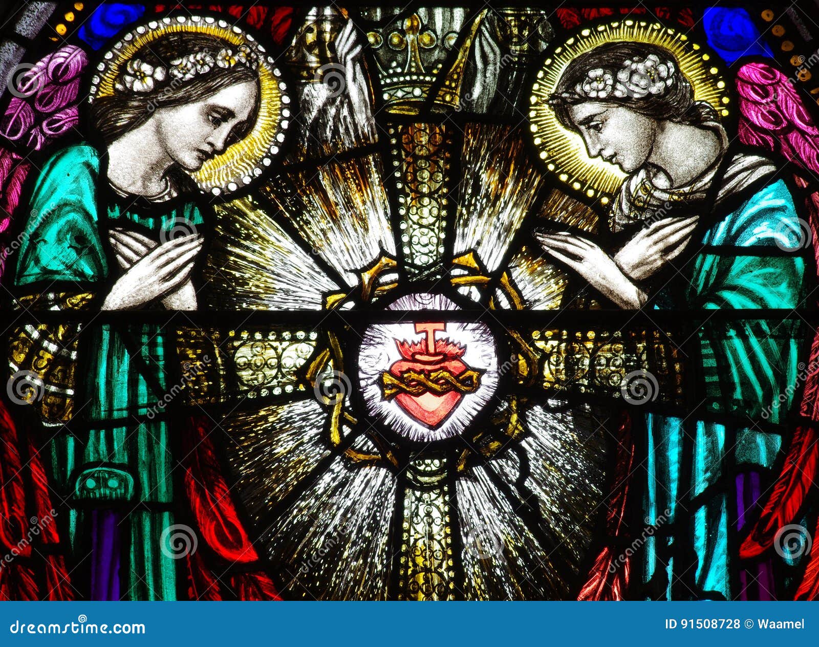 two angels with the sacred heart in stained glass
