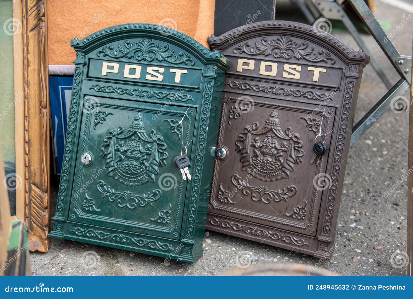 Two Antique Iron Mailboxes in Green and Black on the Street Stock Photo