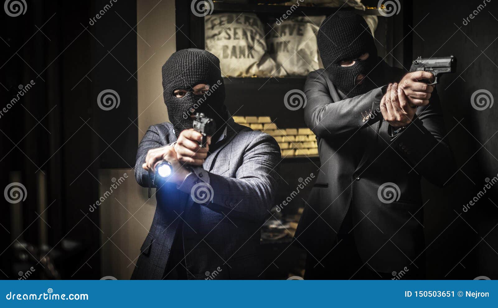 two ardmed men robbing a bank