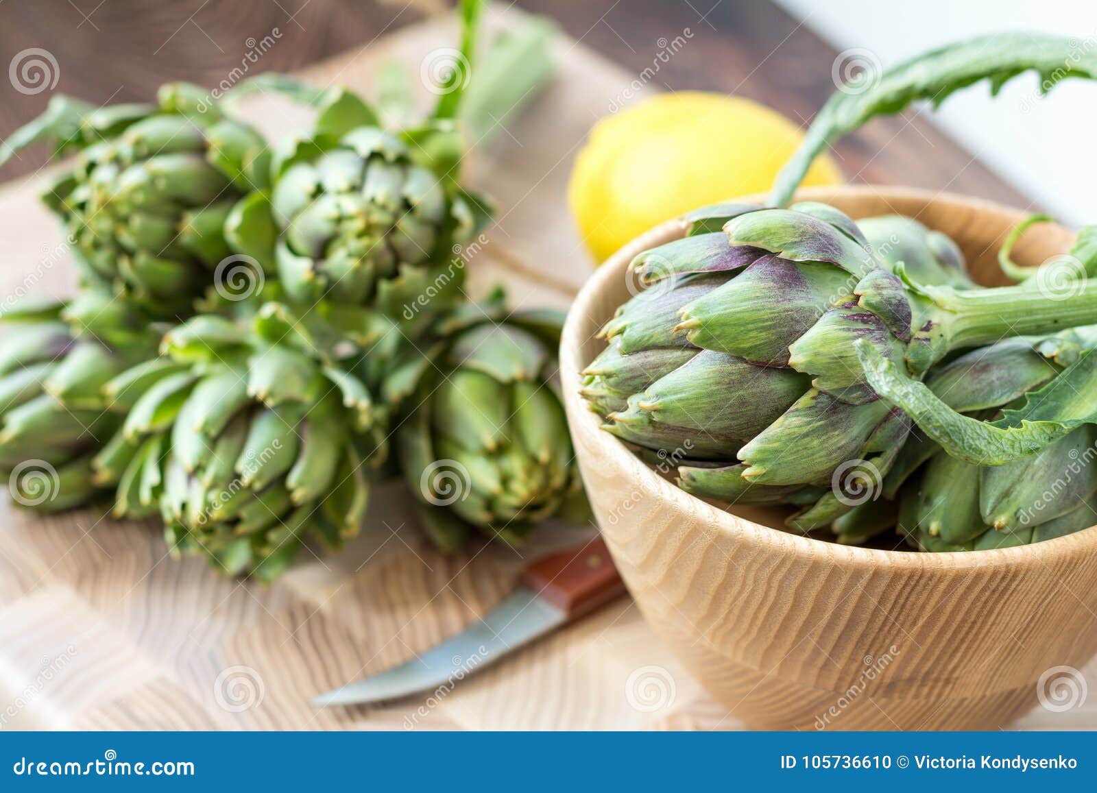 Two Artichoke Bouquets on Kitchen Table among Some Kitchen Items Stock