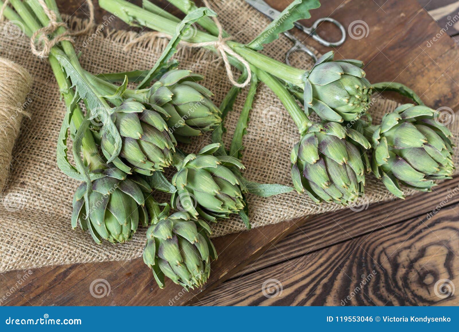 Two Artichoke Bouquets on Kitchen Table among Some Kitchen Items Stock