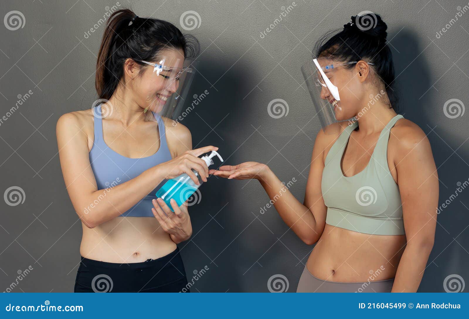 Two Asian Beautiful and Healthy Women Wearing Face Shield or Mask To  Protect Virus, Sport Bra, Washing Hands with Alcohol Gel and Stock Image -  Image of female, protection: 216045499