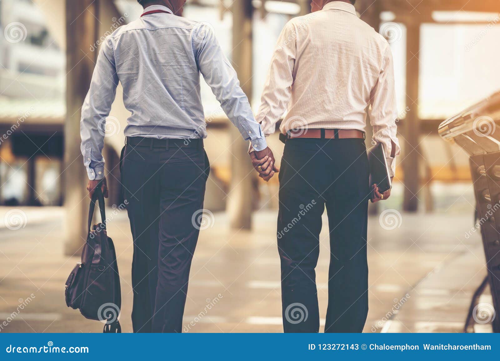 Two Asian Business Men are Walking Hand in Hand and Taking Care Stock Image 