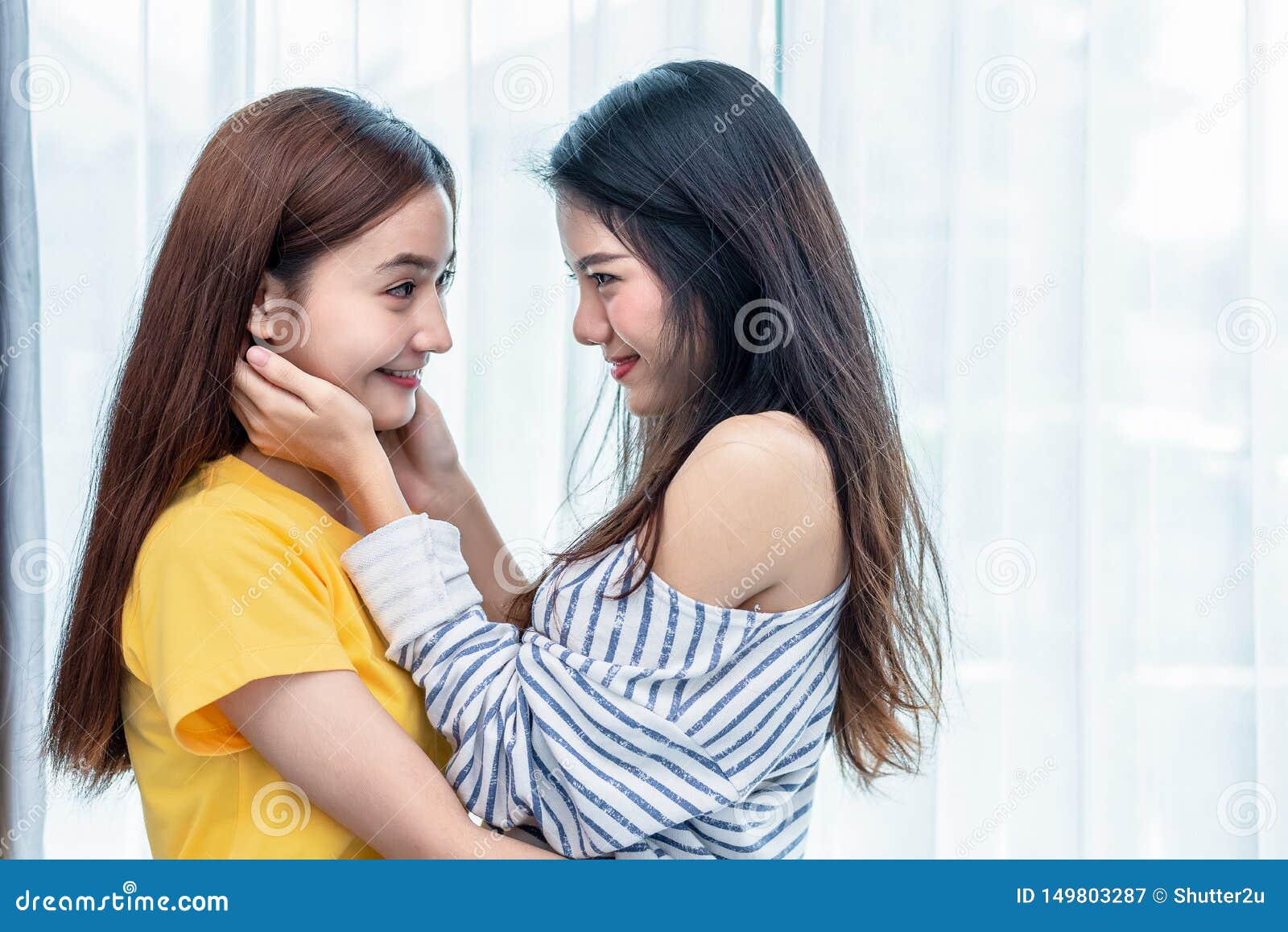 two asian women looking at each others in home. people and lifestyles concept.  lgbt pride and lesbian theme