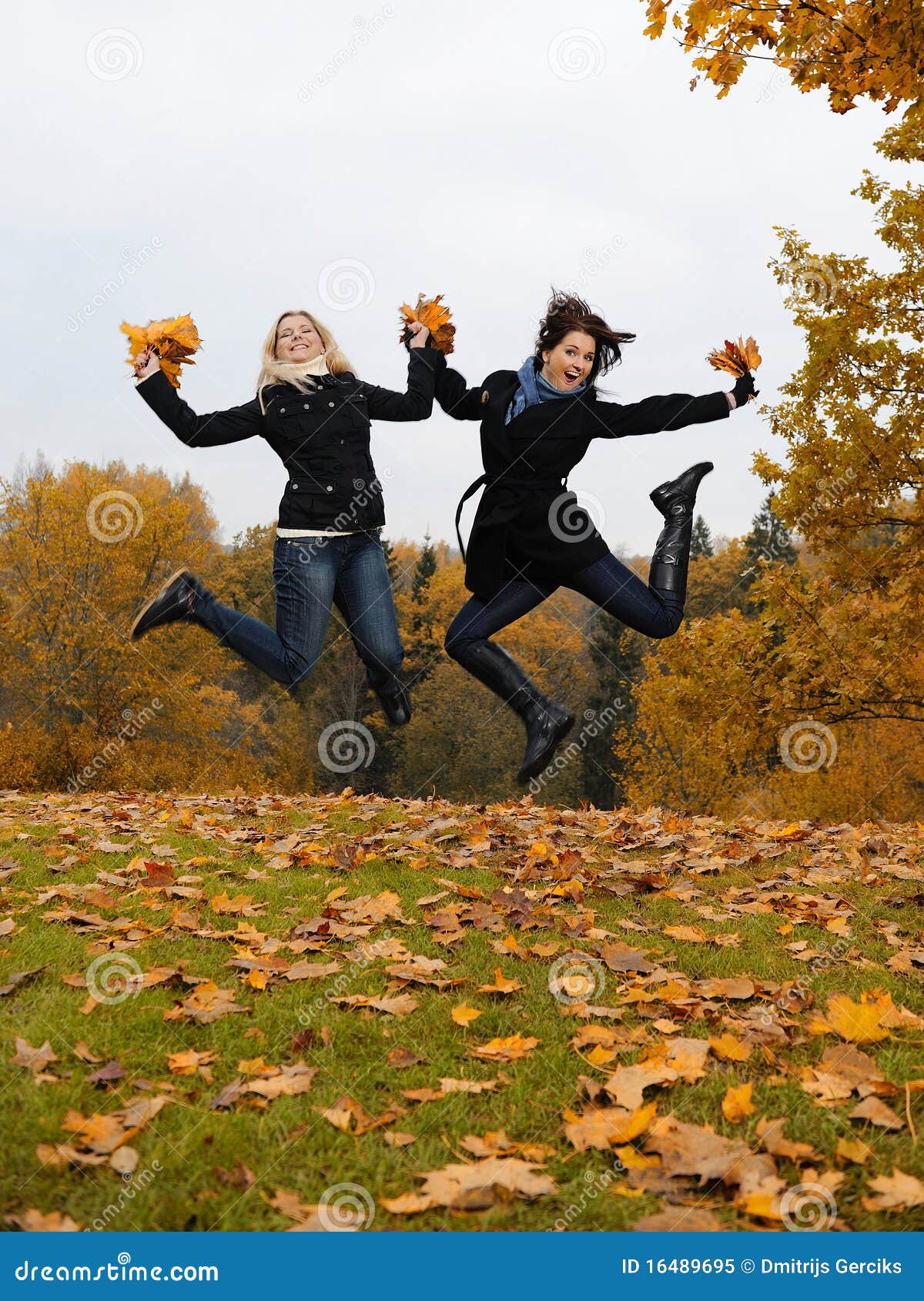 Two Autumn Girl Friends In A Park Jumping Stock Image Image Of