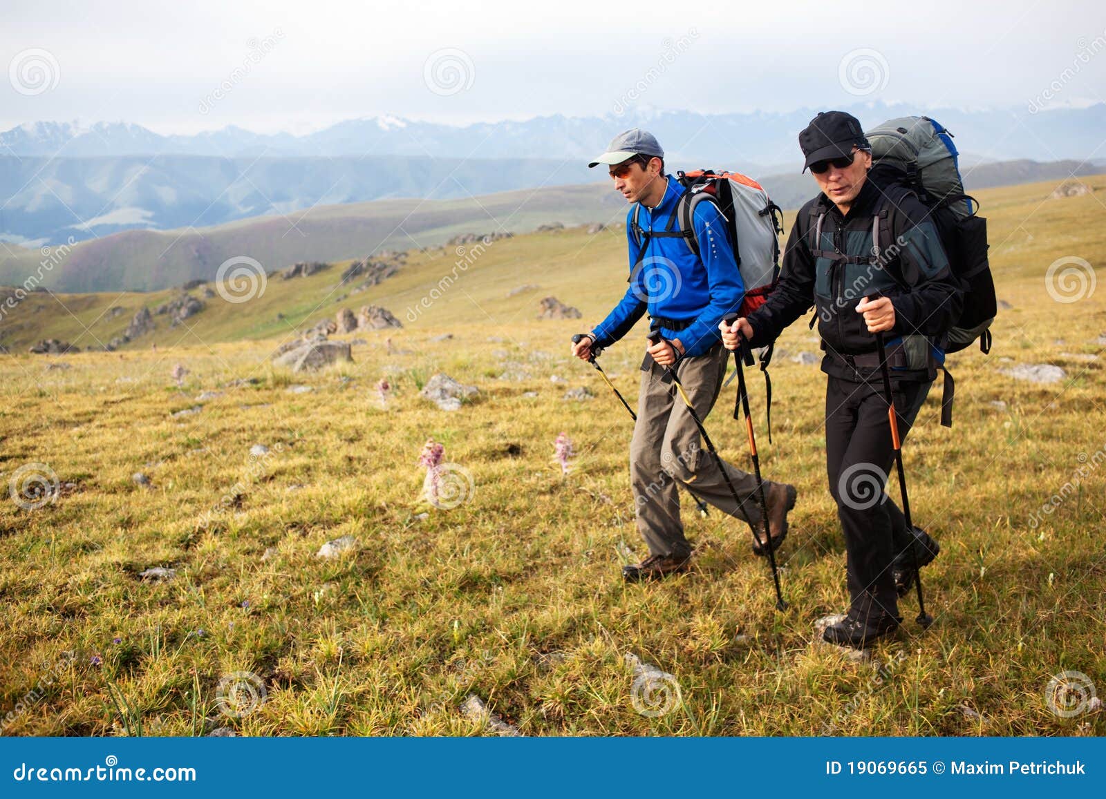 two backpackers in mountains