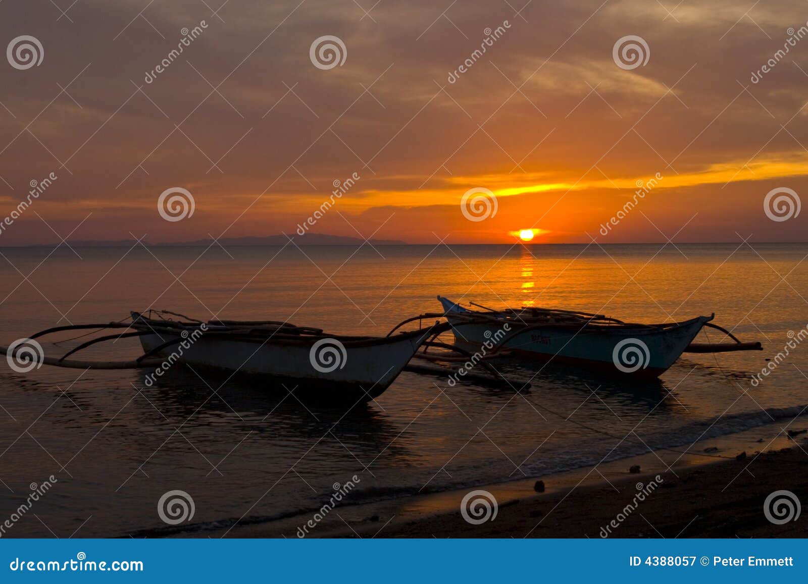 two banca boats at sunset on beach