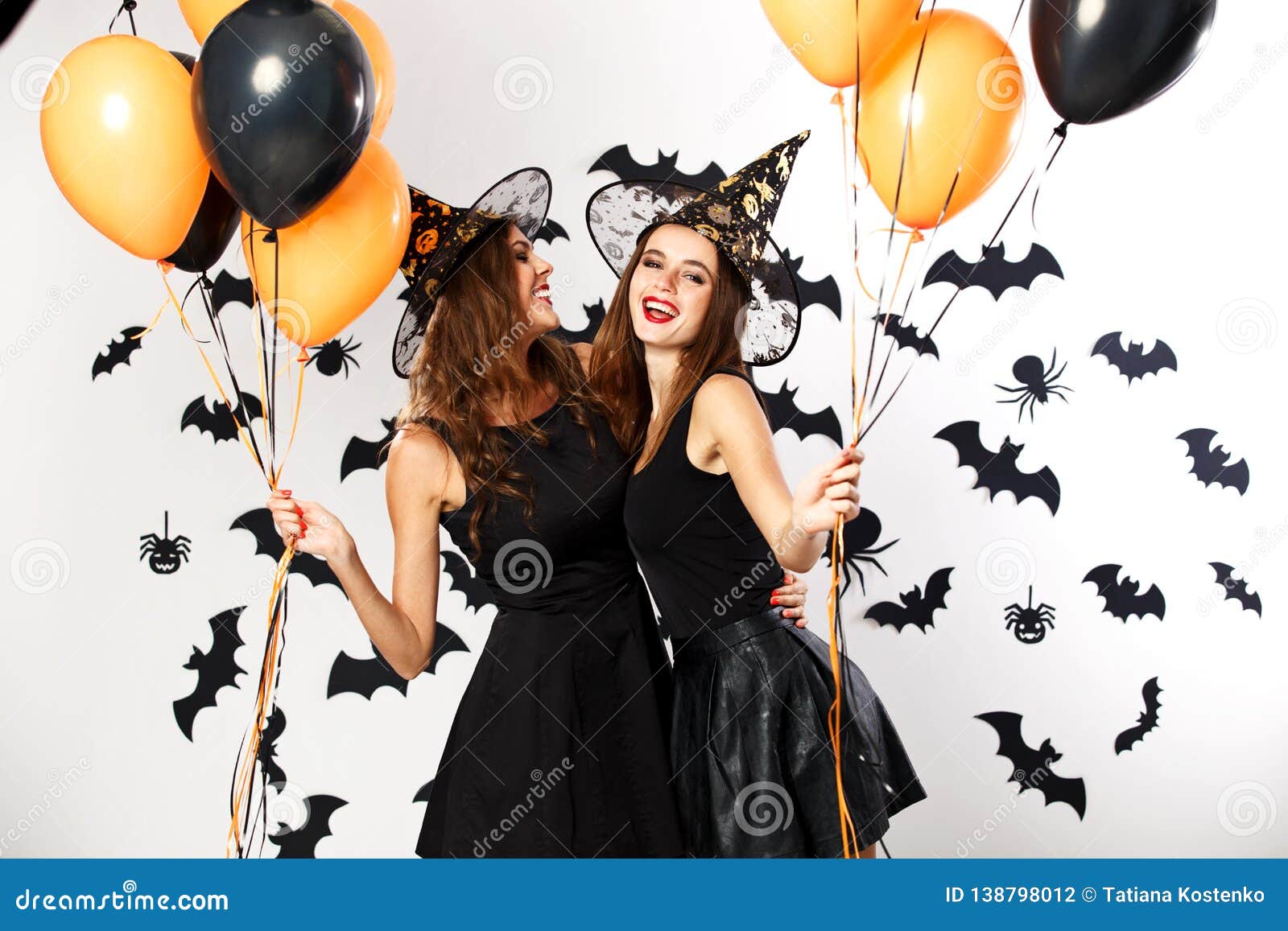 Two Beautiful Brunette Girls Dressed in Black Dresses and Witch Hats ...