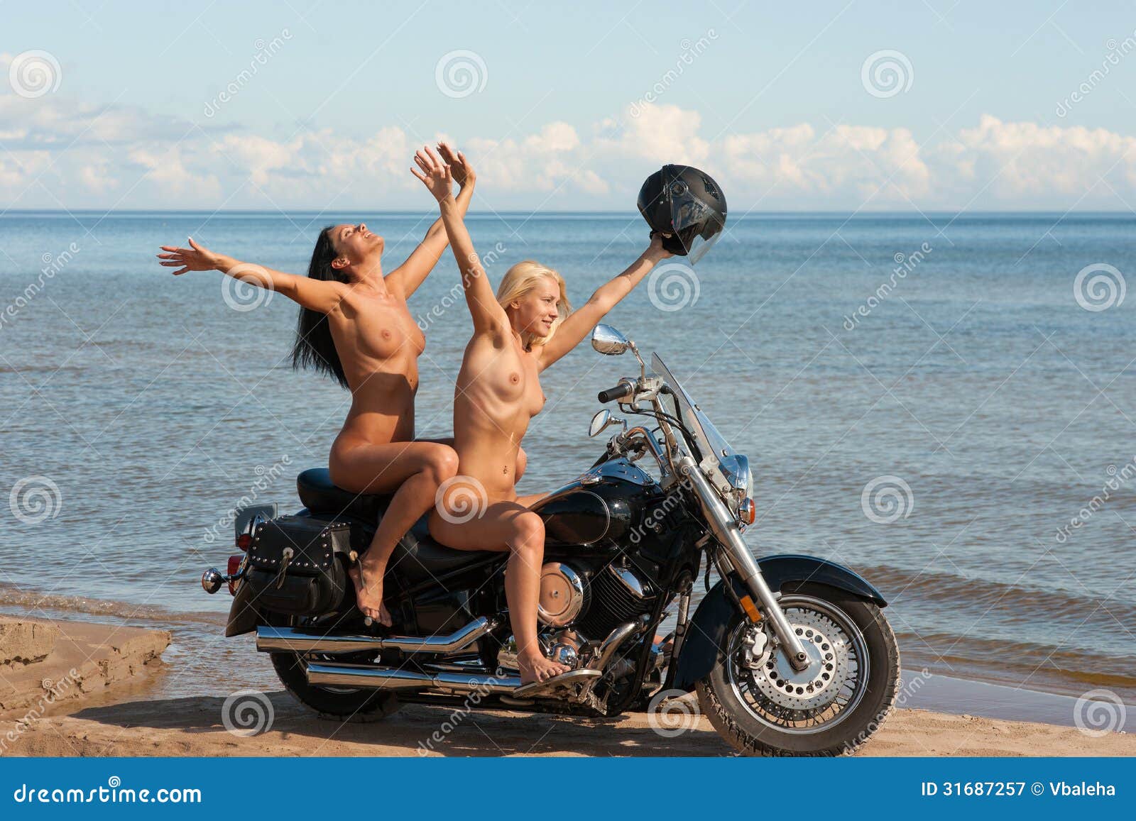 two-beautiful-naked-women-motorcycle-against-sea-background-