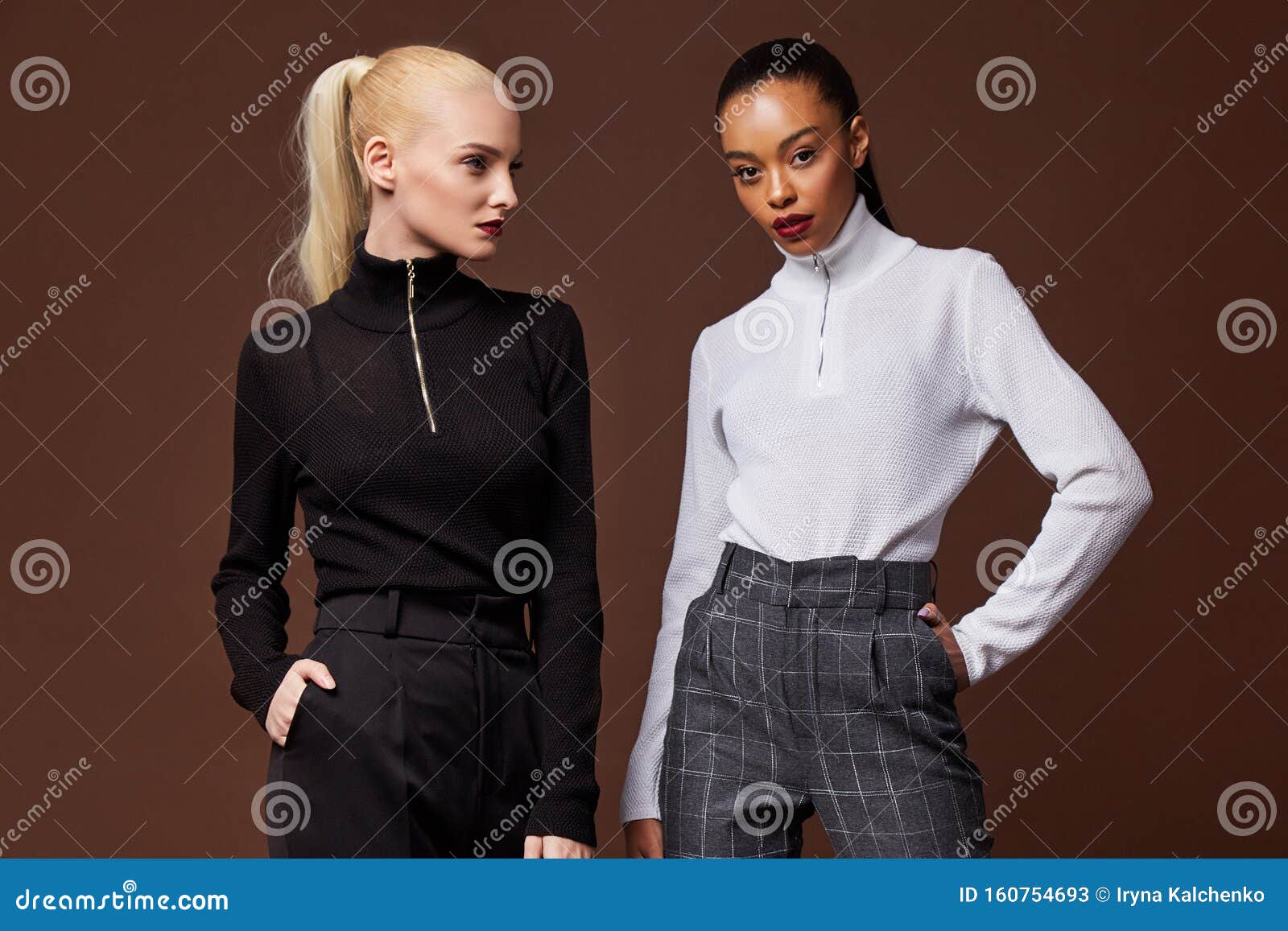 two beautiful sexy woman long brunette blond hair glamour model wear pants and sweater work office style dress code accessory