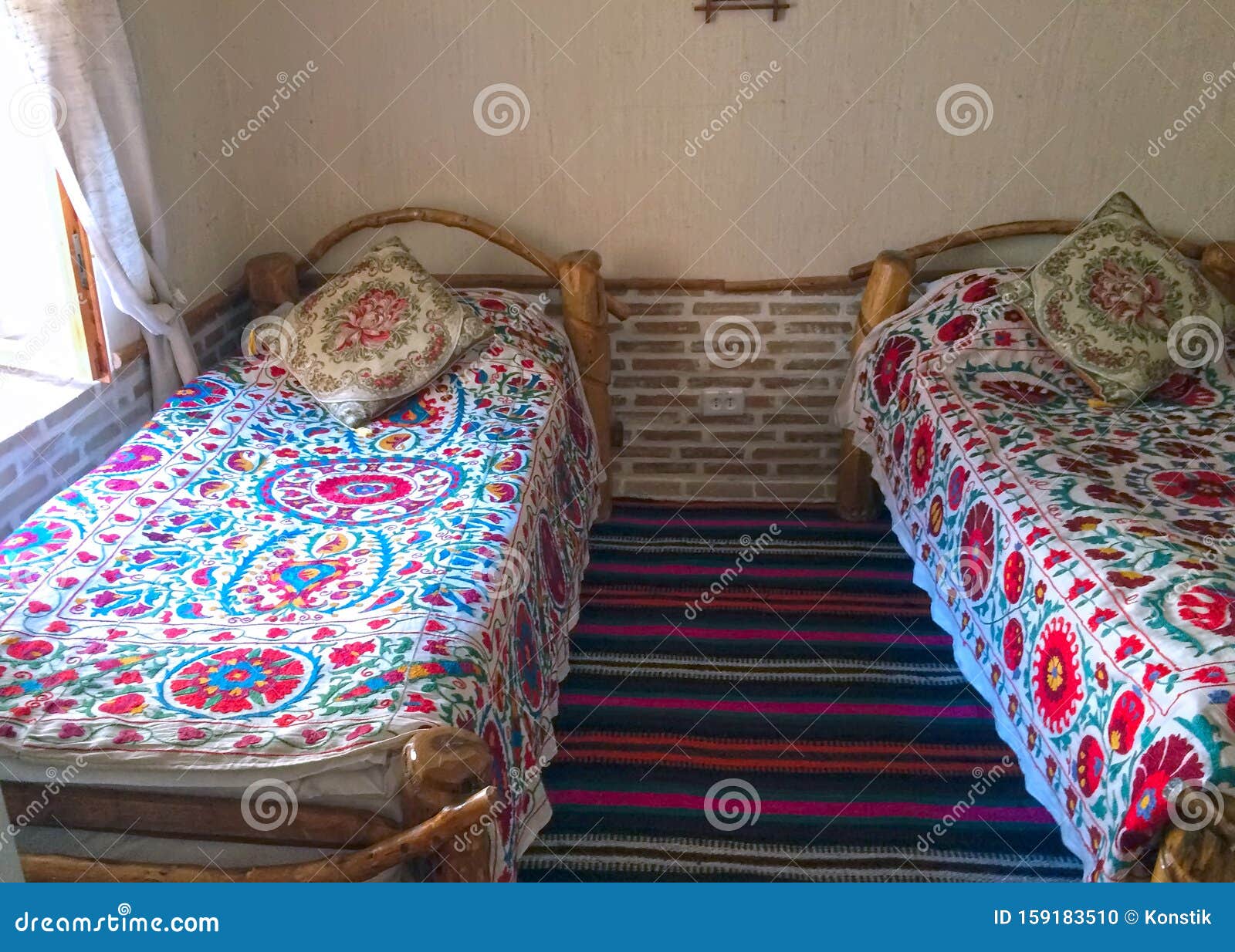 Two Beds with a Traditional Uzbek Pattern on the Bedspread Stock Photo