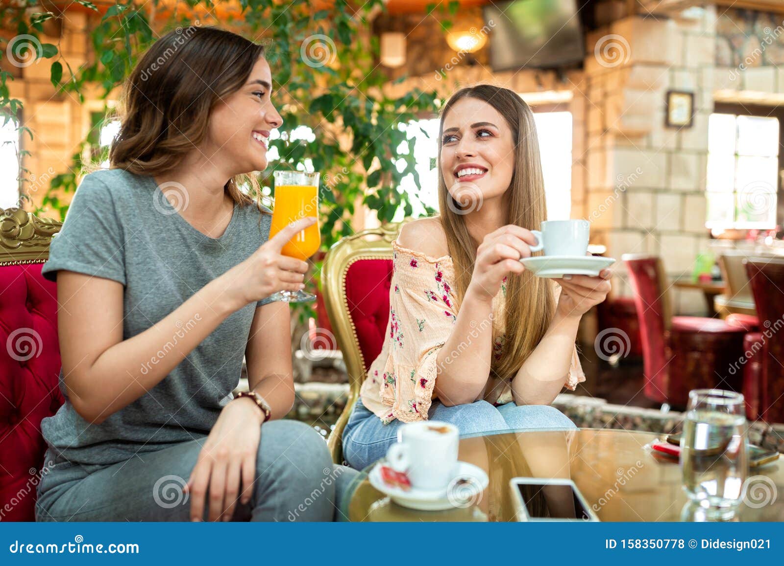 Two Best Friends Drinking Coffee and Orange Juice Stock Photo Image