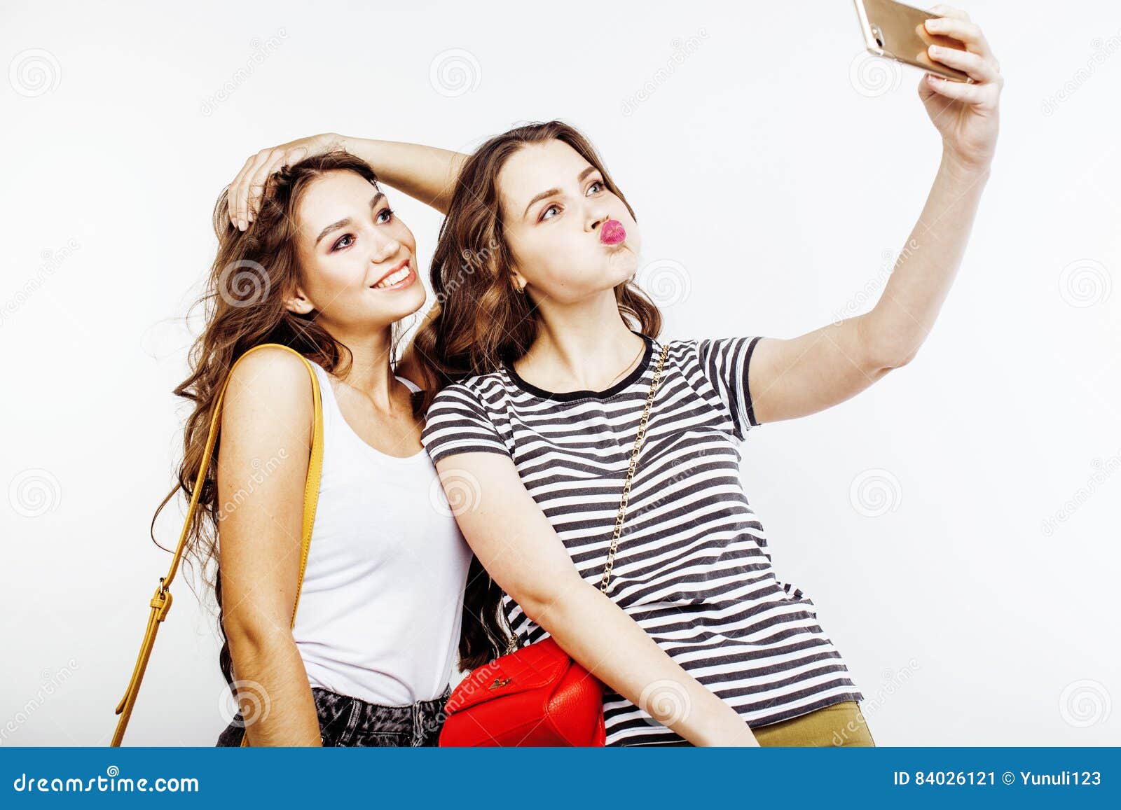 Two emotional female friends in jeans jackets posing while making selfie in  city cafe Stock Photo - Alamy