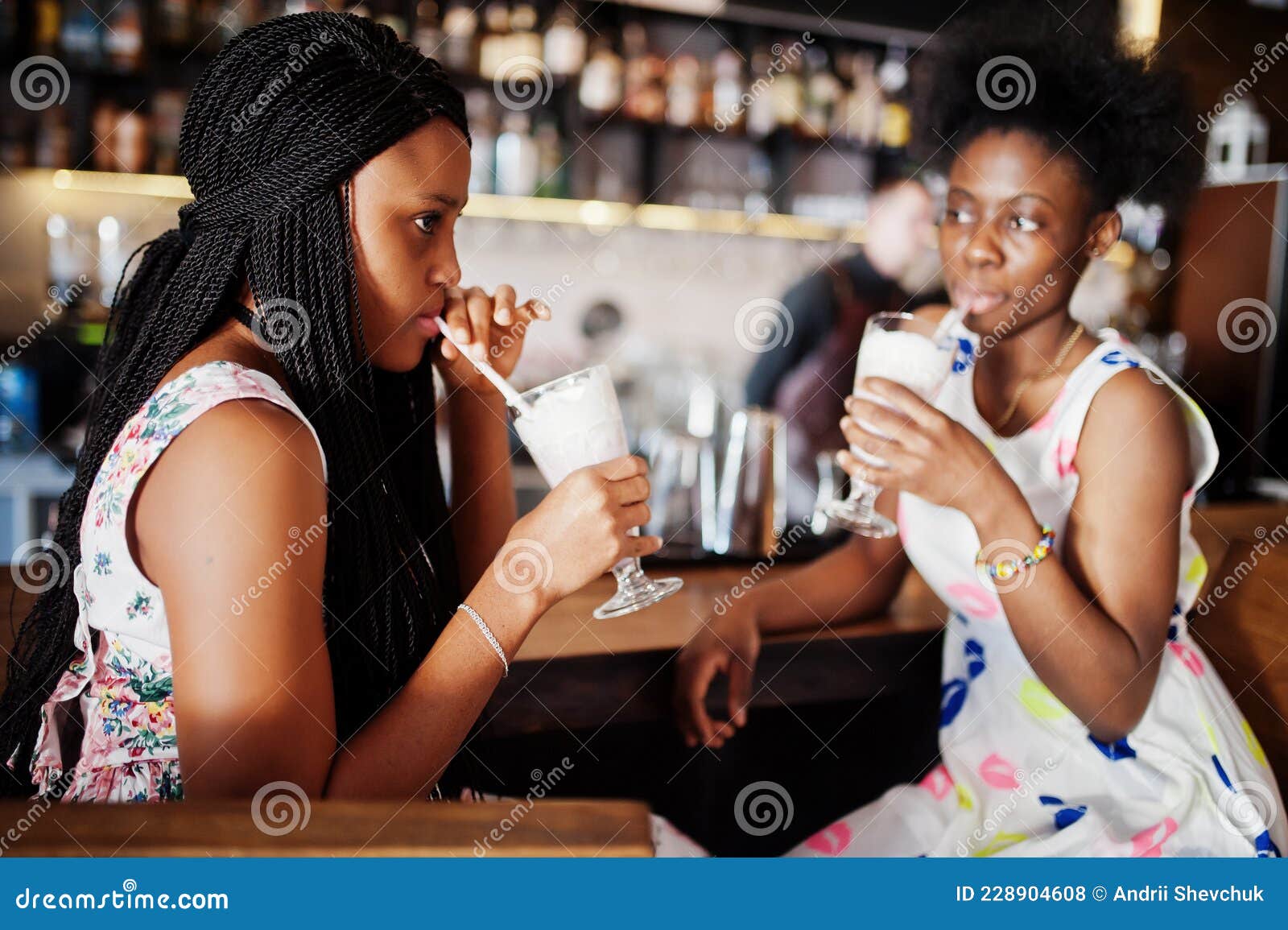 Two Black African Girlfriends at Summer Dresses Posed at Caf