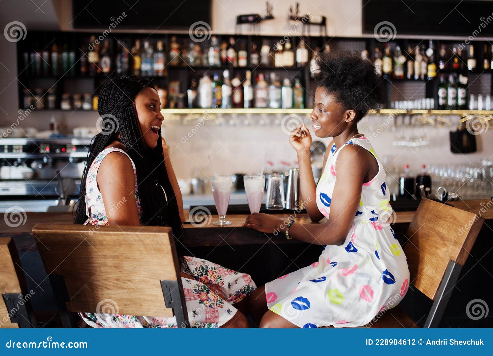 Two Black African Girlfriends at Summer Dresses Posed at Caf image photo