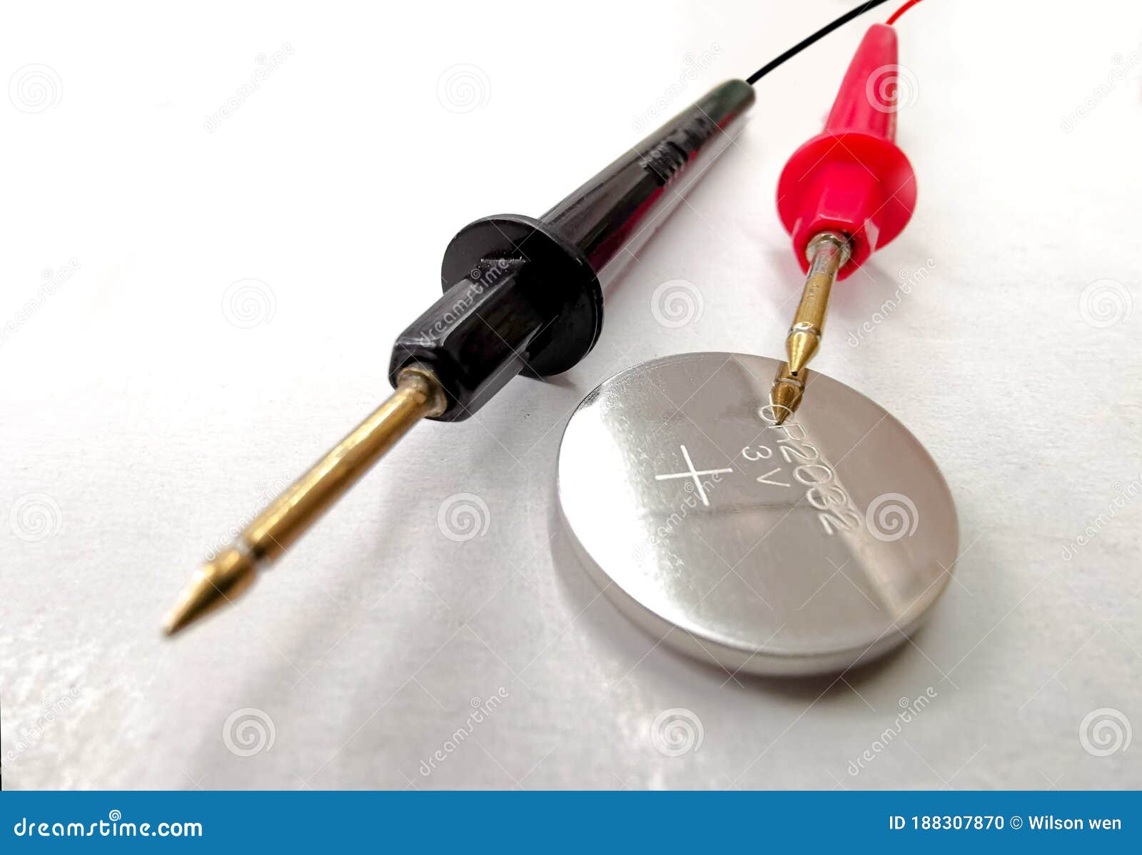 Two Black and Red Battery Tester Cables with a 3 Volt Button Battery on