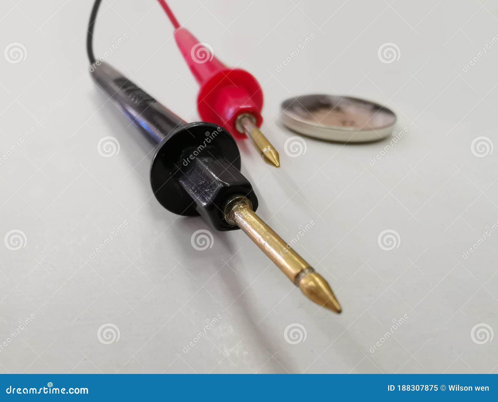 Two Black and Red Battery Tester Cables with a 3 Volt Button Battery on