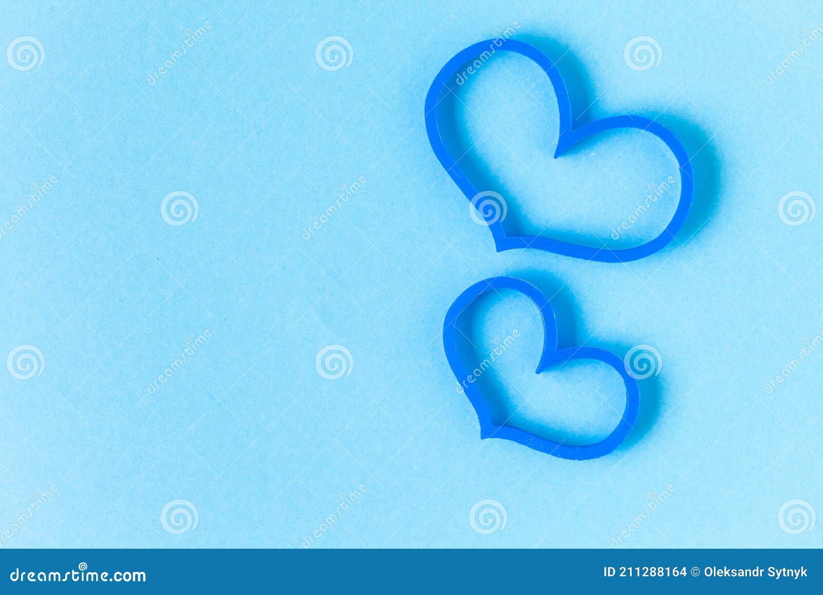 Two Blue Heart Shaped Figures on the Light Blue Background. Love