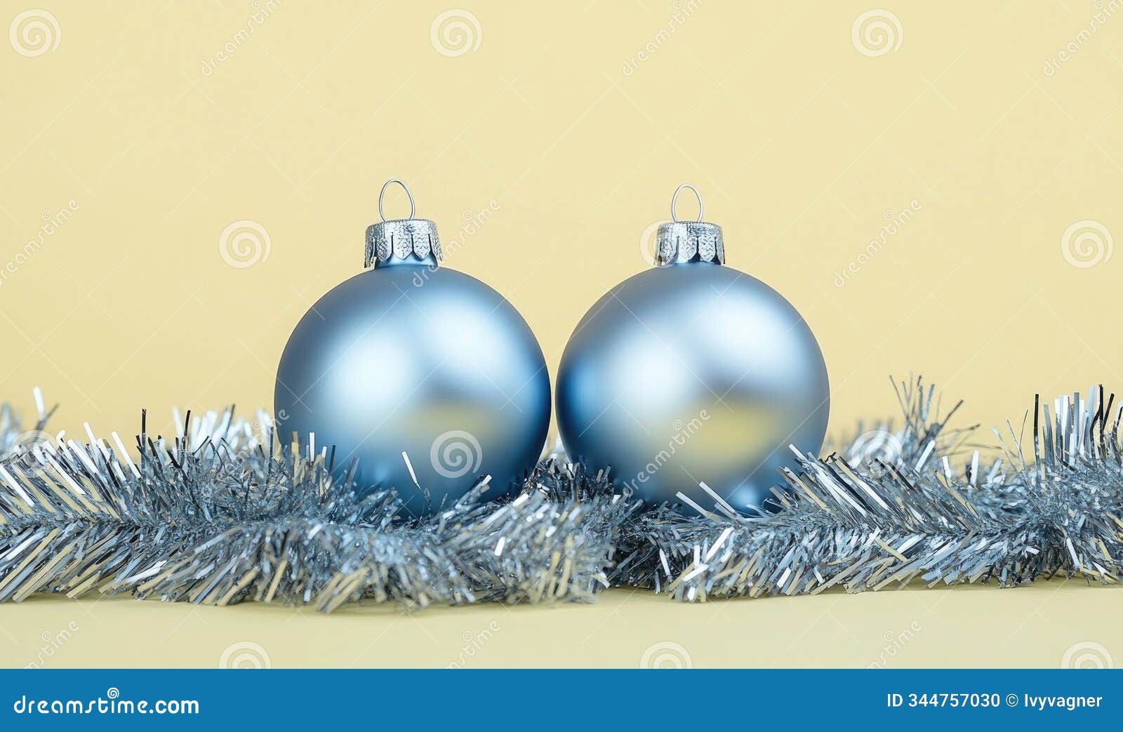 two blue ornaments are sitting on a gold background