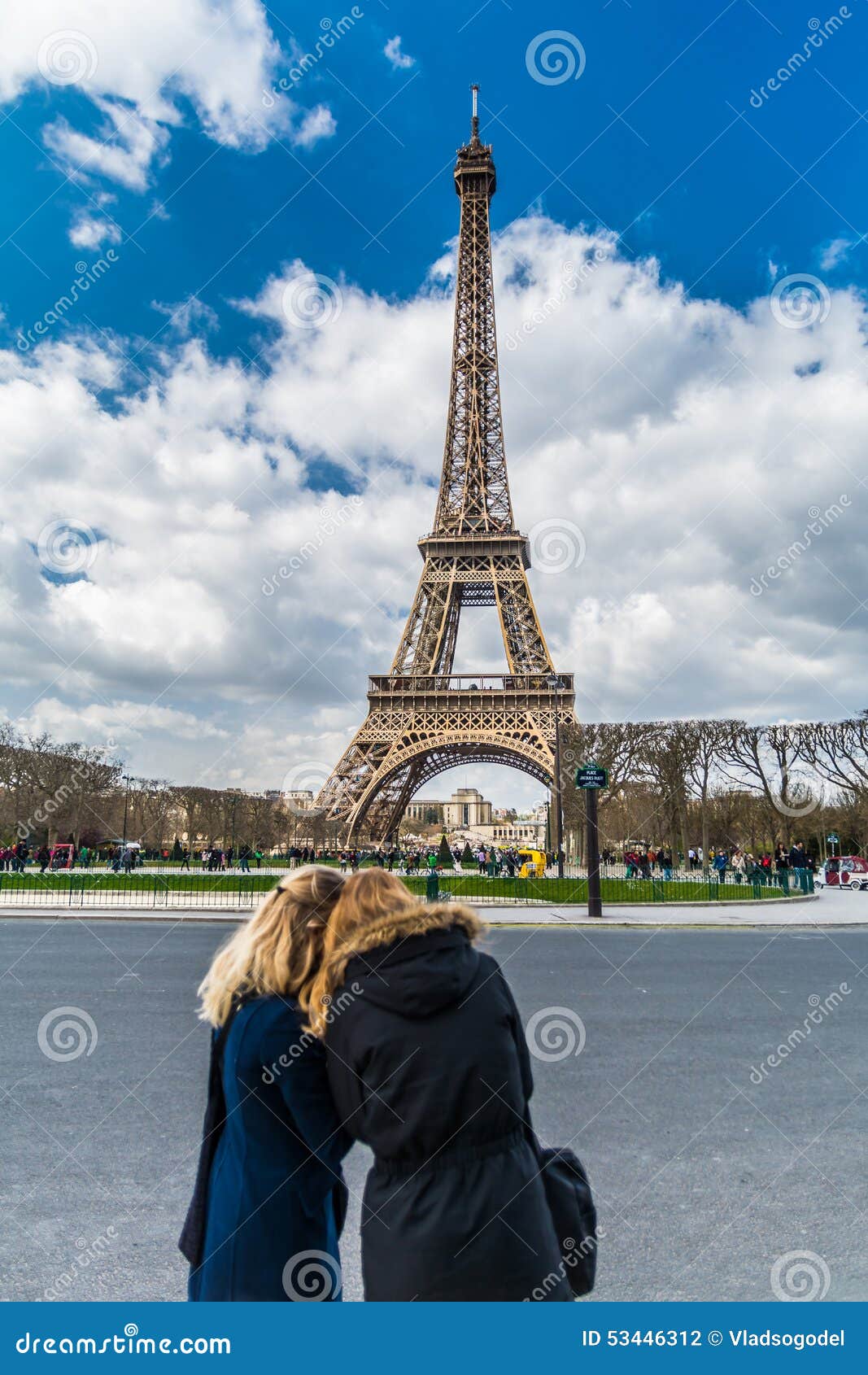 two blurry blonde tourist girls silhouette over eiffel tower in paris