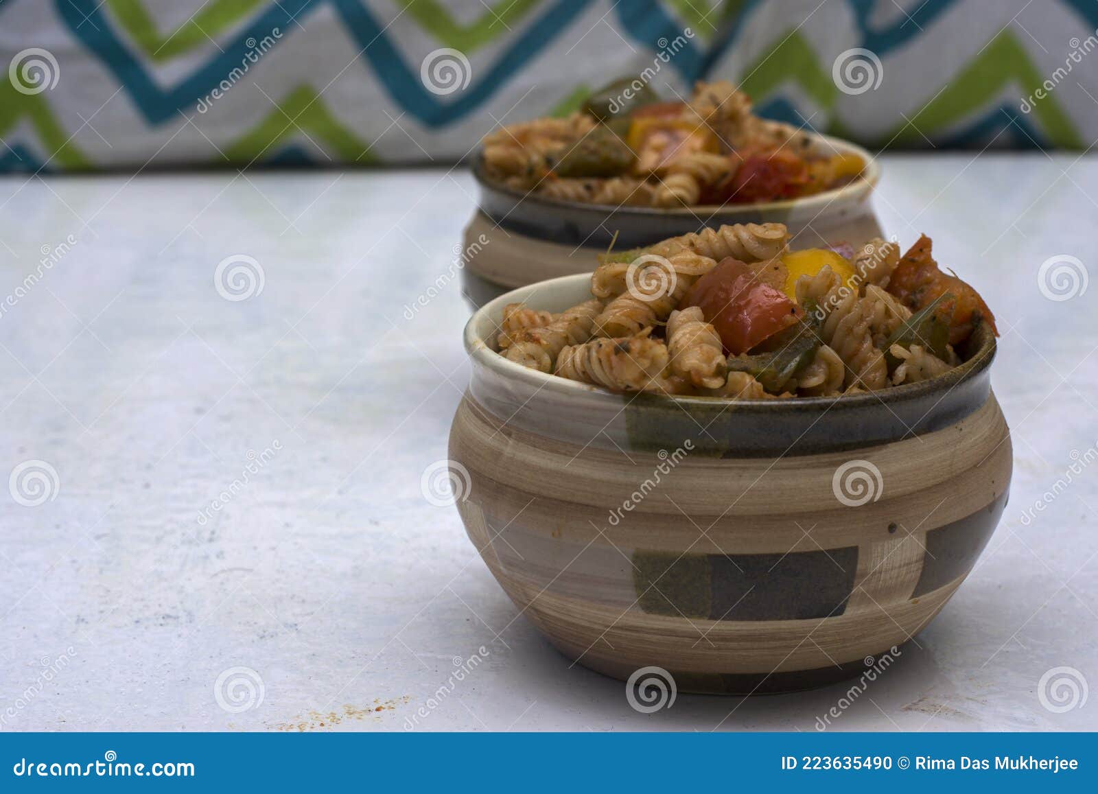 Two Bowls of Italian Pasta with Bell Papers on a White Background Stock