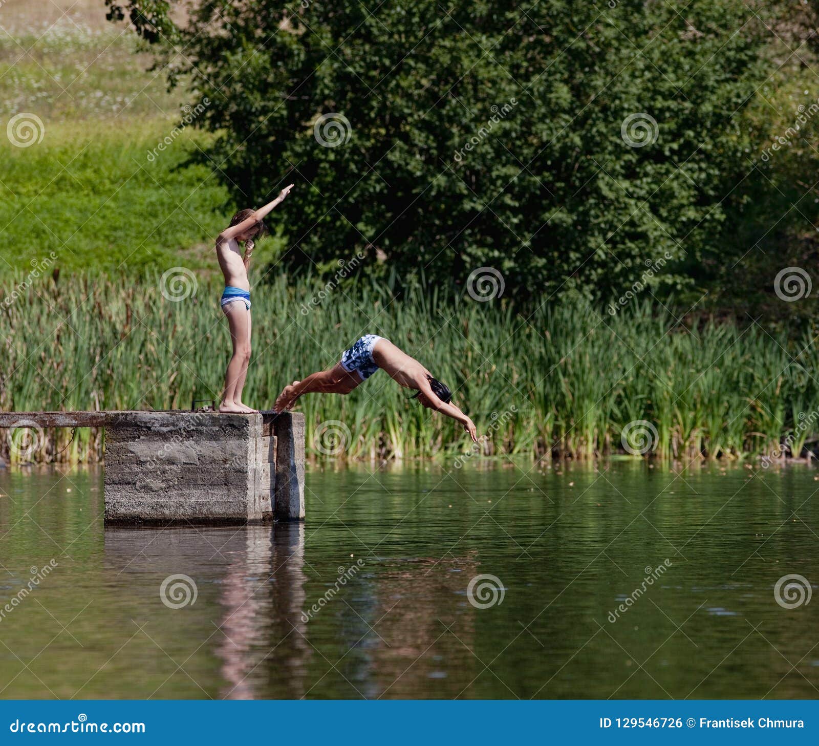 Two Boys Diving In The Lake Stock Photo Image Of Long Water 129546726