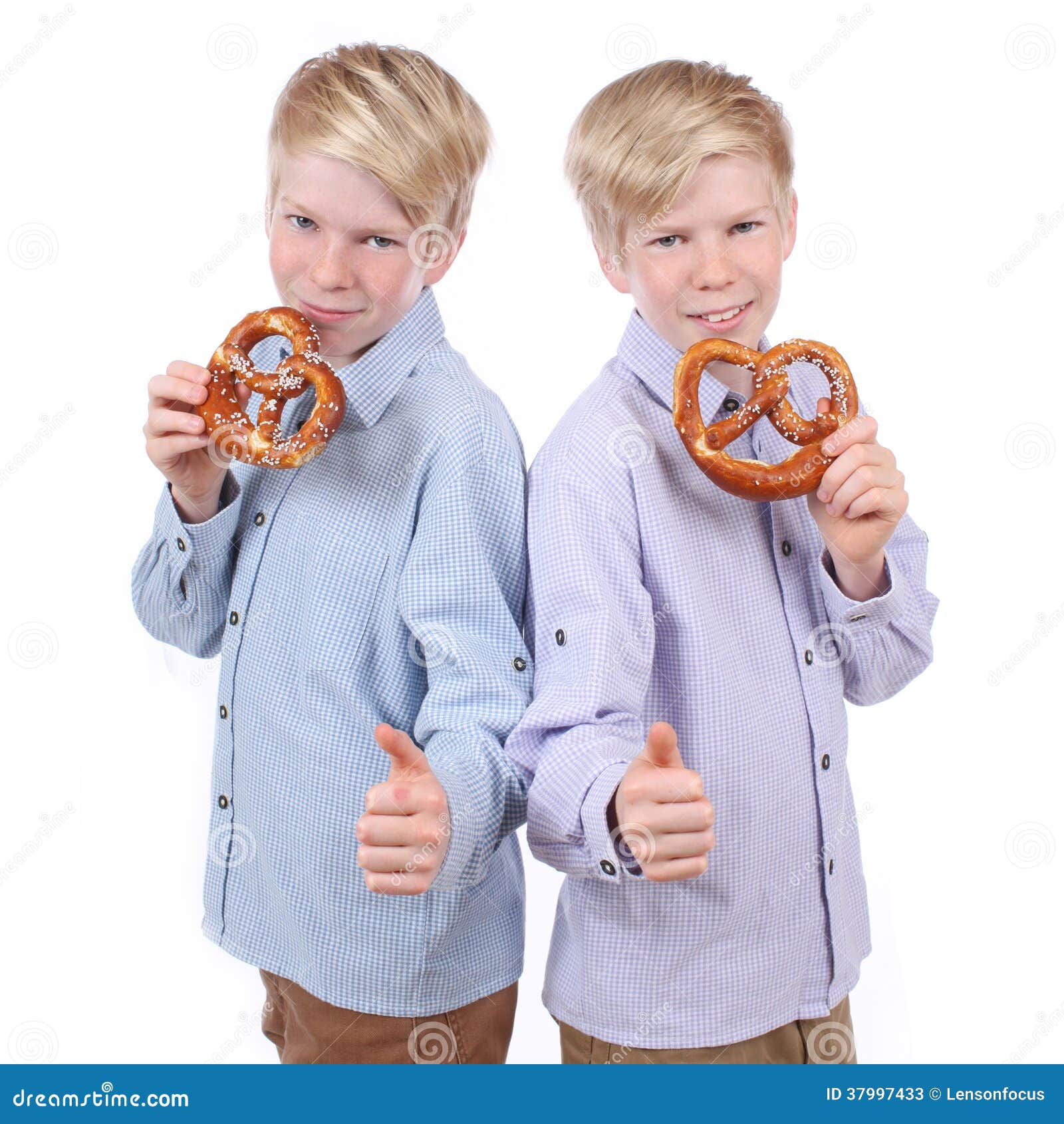 Two boys eating pretzels stock image. Image of dress 37997433